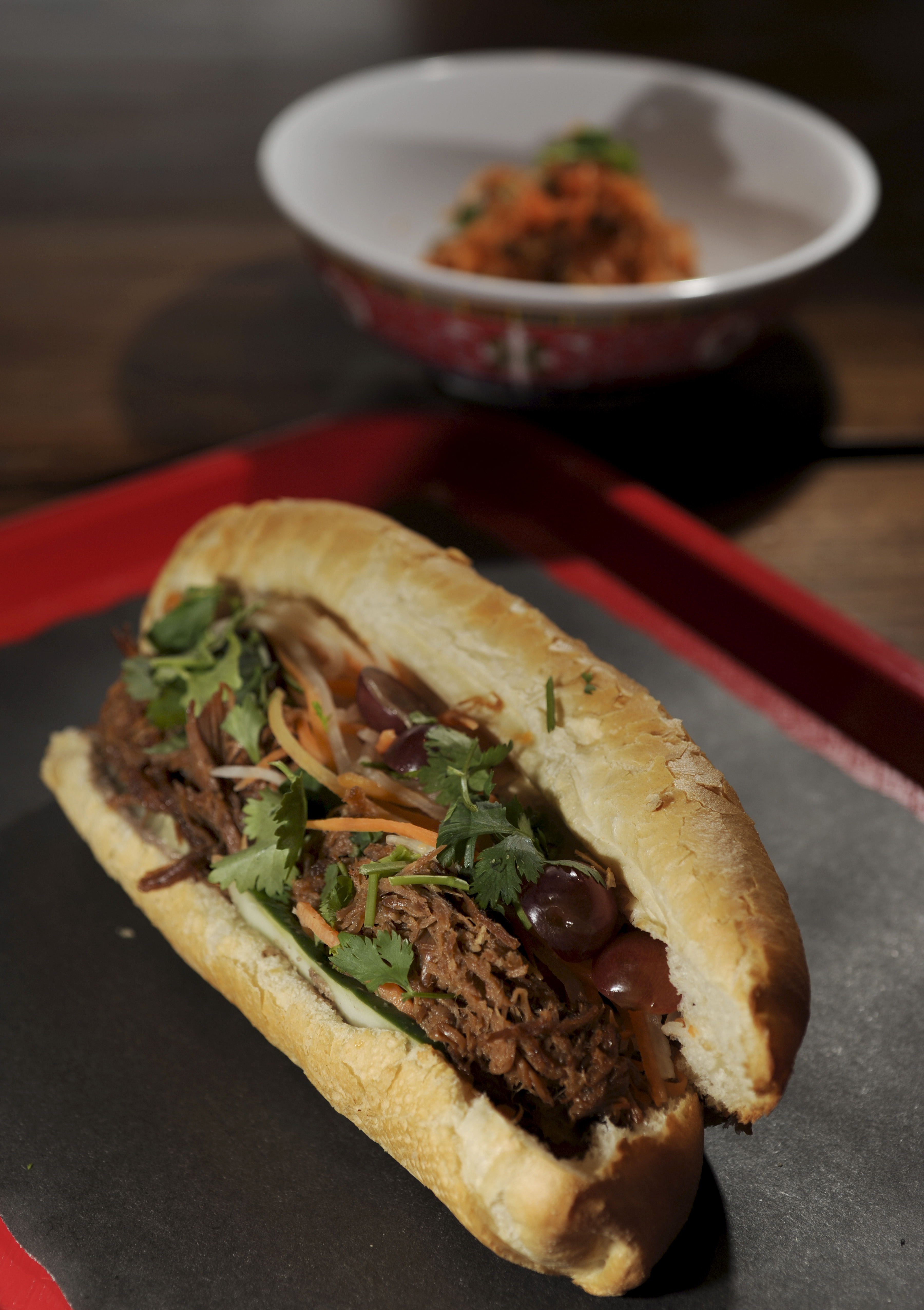 Sa Pa Modern owner Ky Nguyen serves up Banh mi with pulled pork.