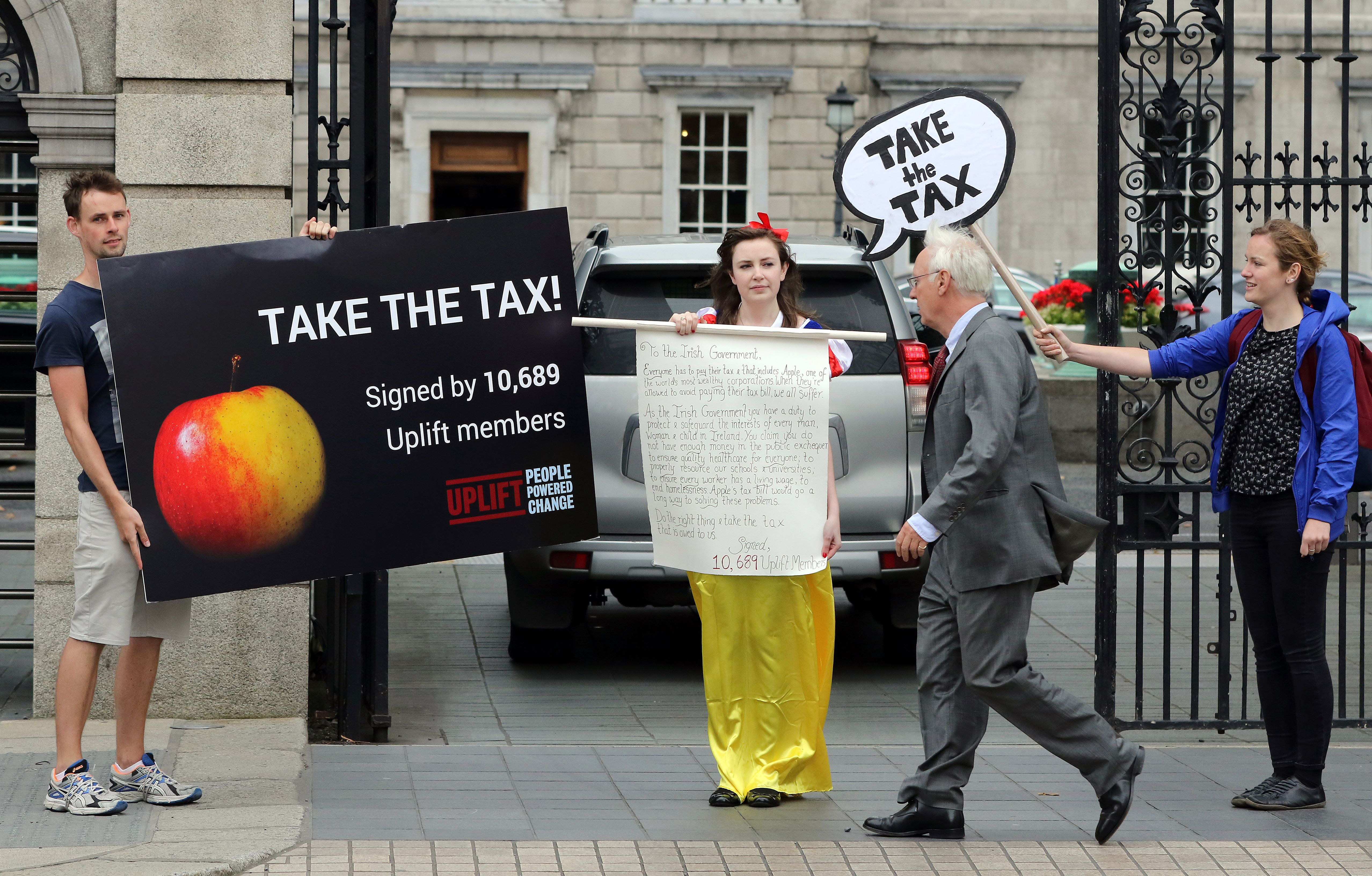 The European Union has been aggressively cracking down on tax avoidance by multinationals. Apple’s use of an Irish subsidiary to lower its tax bill by $14.5 billion, according to the EU, draws protesters outside the parliament building in Dublin.