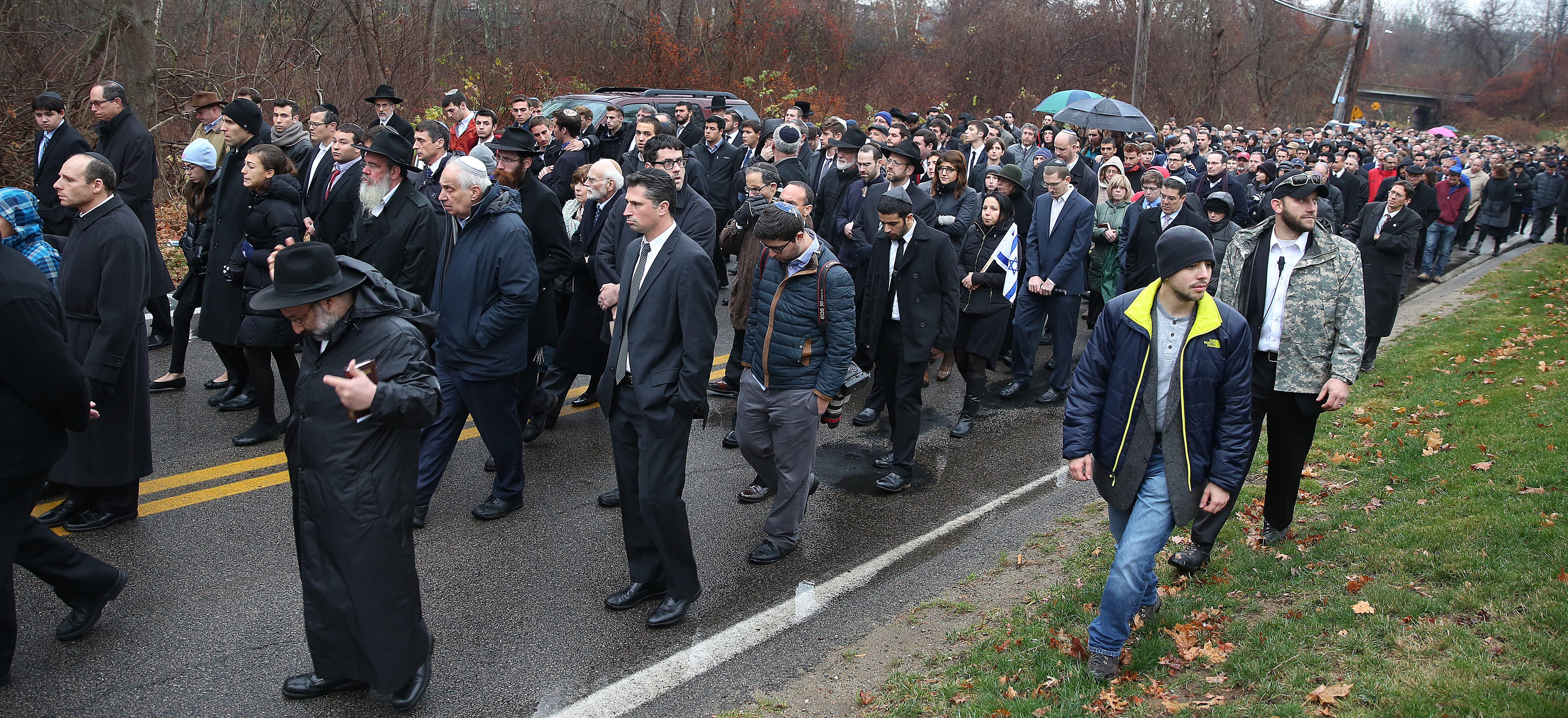 Mourners walked to Sharon Memorial Park for Schwartz’s burial.