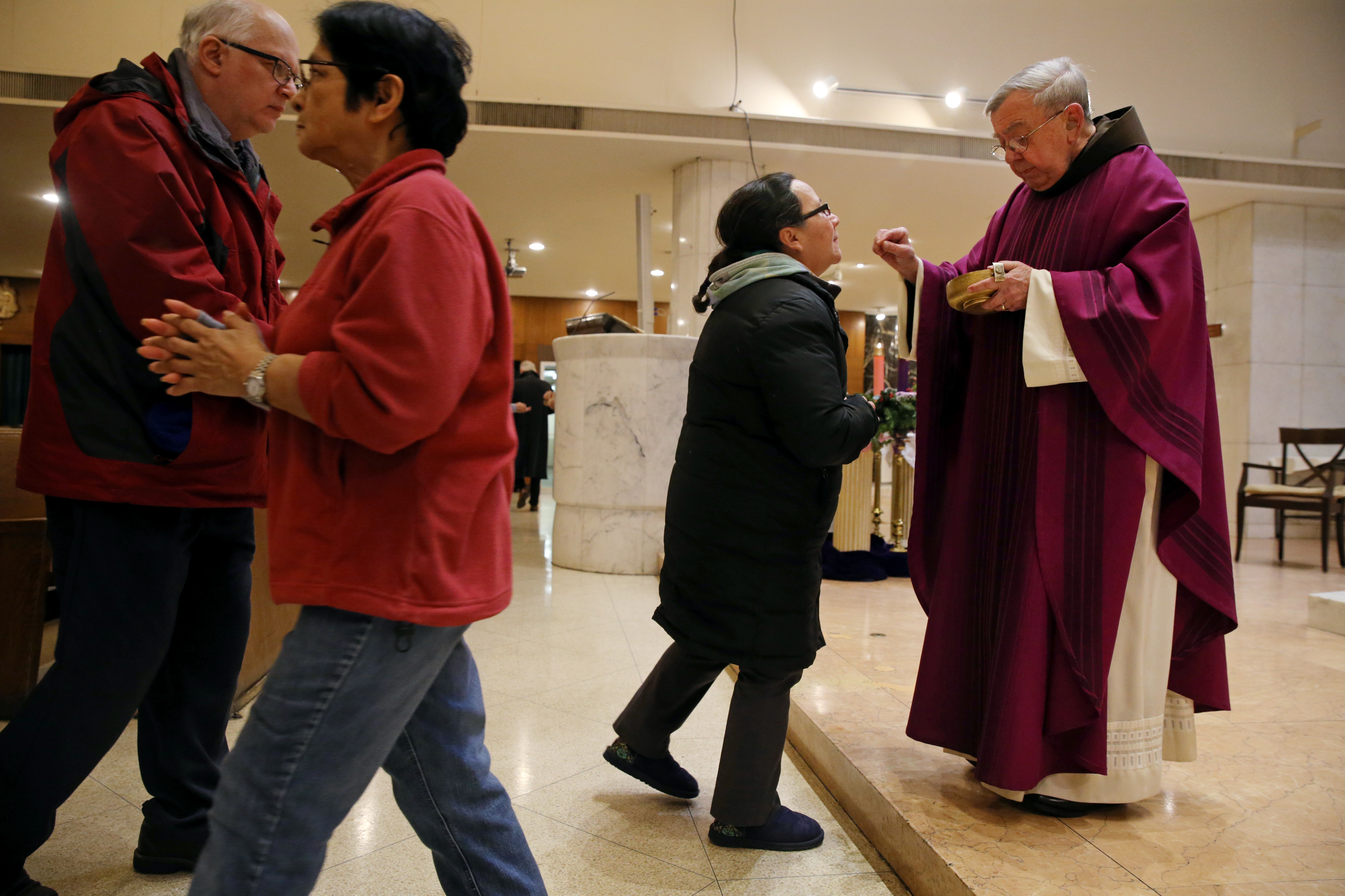 Ronald Stark distributed communion during Mass at St. Anthony Shrine.