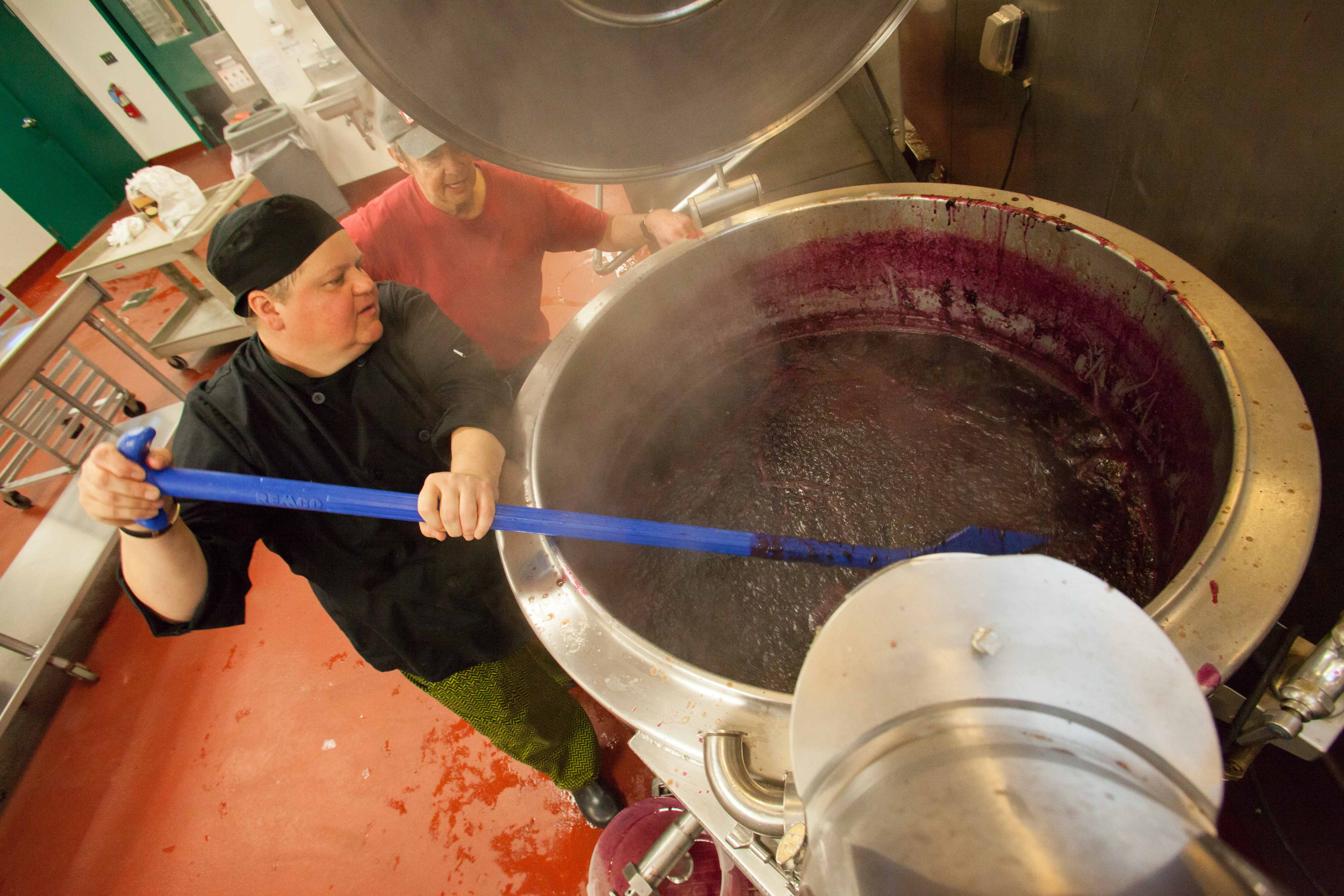 Liz Buxton at the Western Mass Food Processing Center in Greenfield stirred blueberries to make jam for Red Fire Farm in Granby.