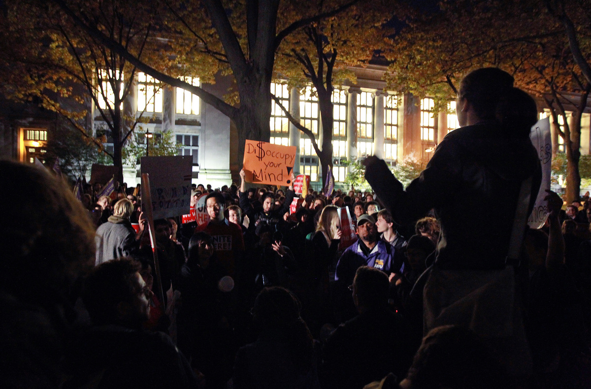 Protesters rallied on the grounds of Harvard Law School last night after being denied access to assemble in Harvard Yard.