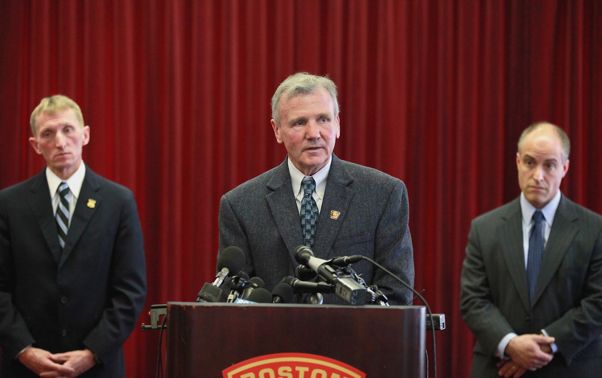Boston Fire Commissioner John Hasson, flanked by Police Commissioner William Evans (left) and Assistant District Attorney Edmond Zabin, spoke to reporters.