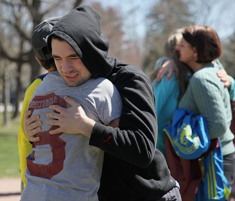 Alan Biggers hugged Ryan Lynch at Wednesday’s vigil.
