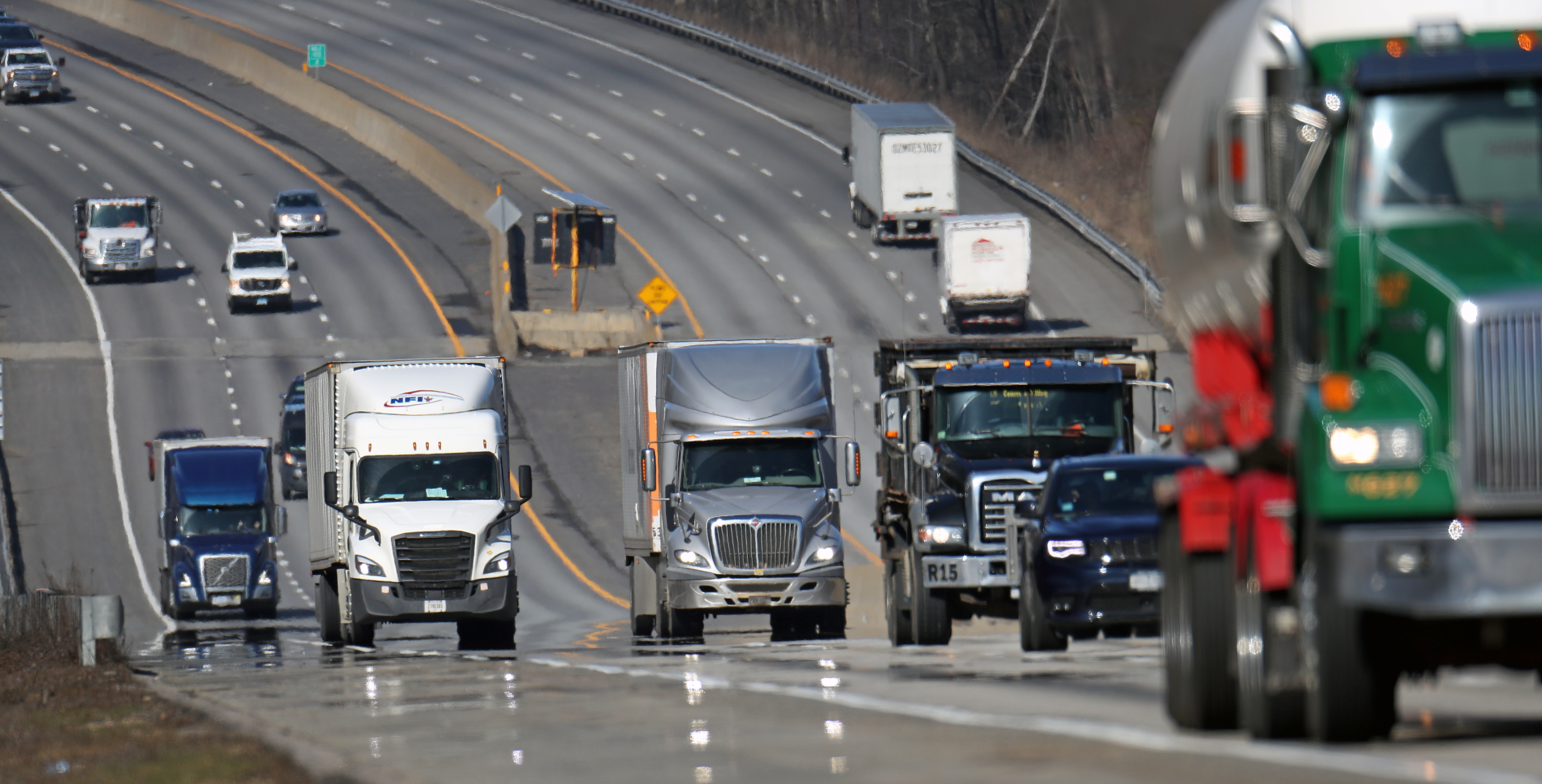 Trucks traveled along the Mass. Pike in Grafton last week.