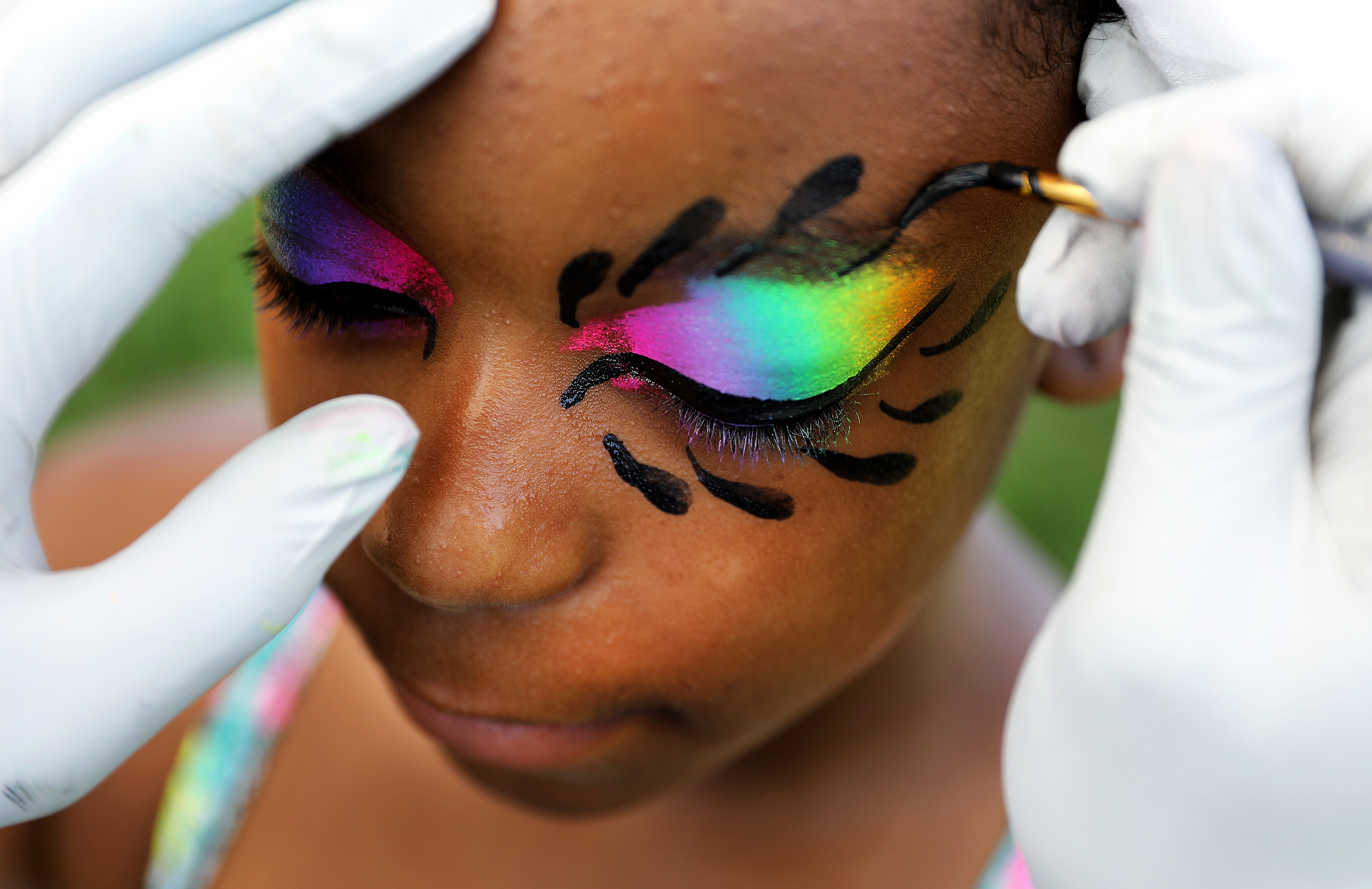 Sanaii Johnson, 12, of Roxbury got her face painted by Vladimir Smith of Dorchester.