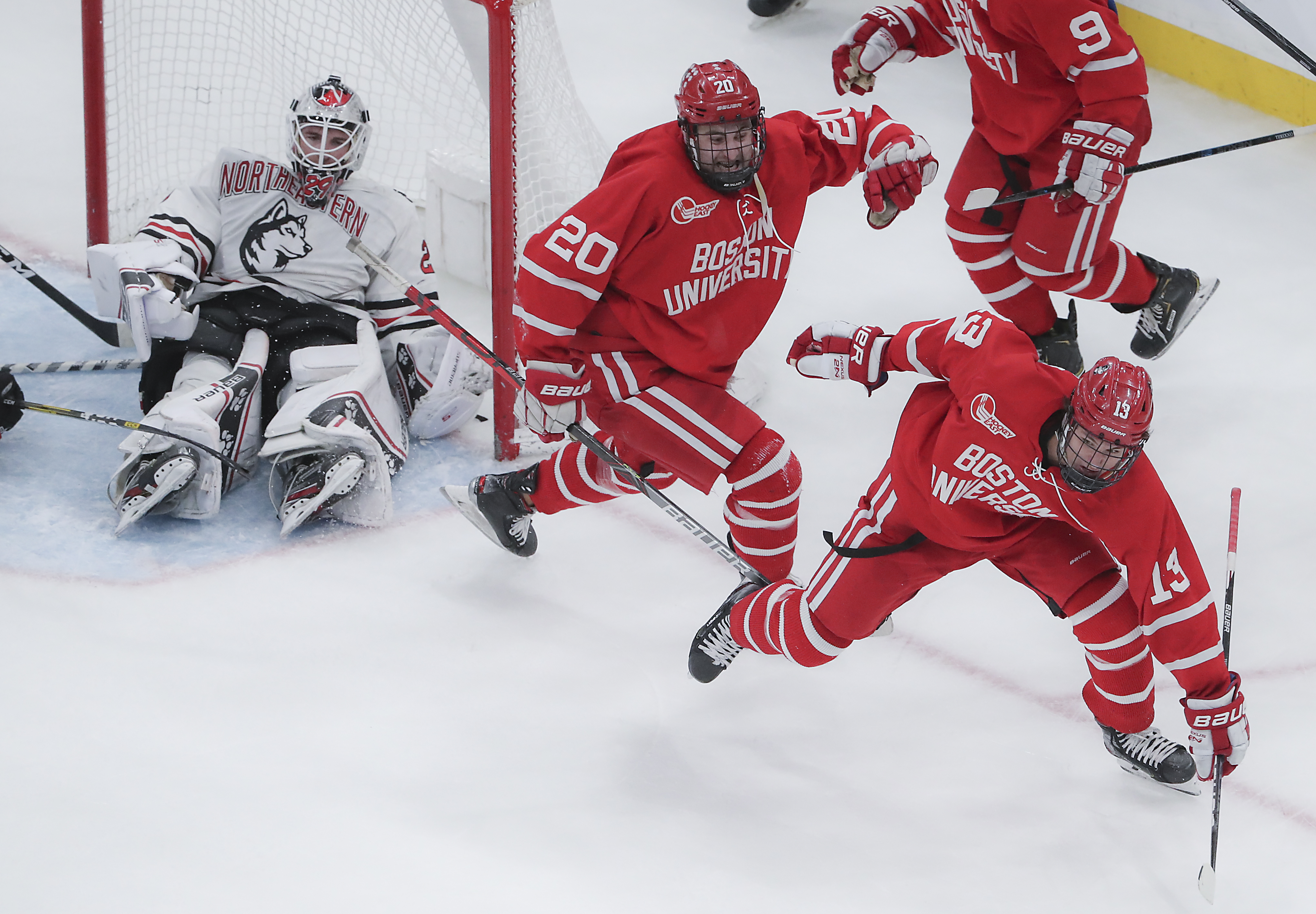 Trevor Zegras (13) celebrates his game-tying goal with 1.2 seconds left, forcing Northeastern goalie Craig Pantano and the Huskies into some extra work to defend their title.