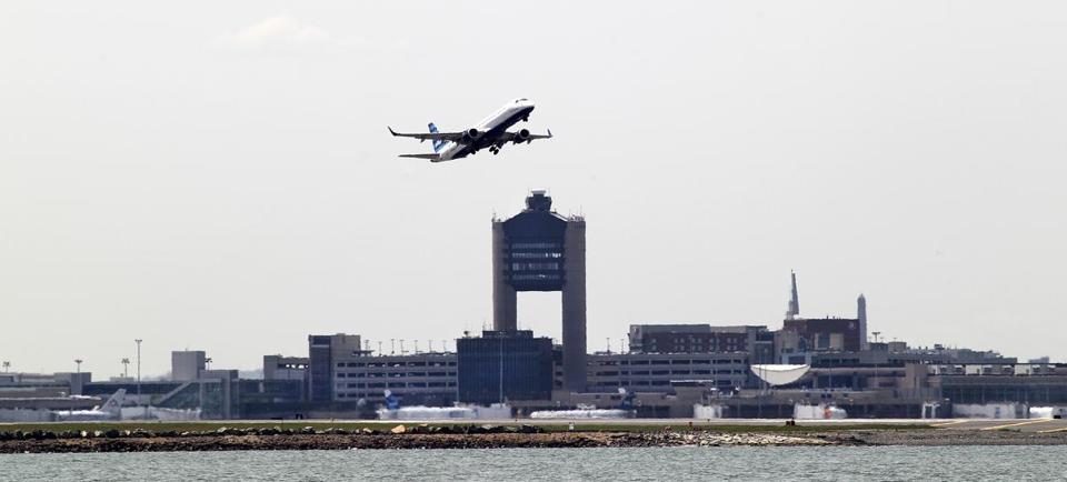 View from Deer Island of a passenger jet taking off from Logan Airport.