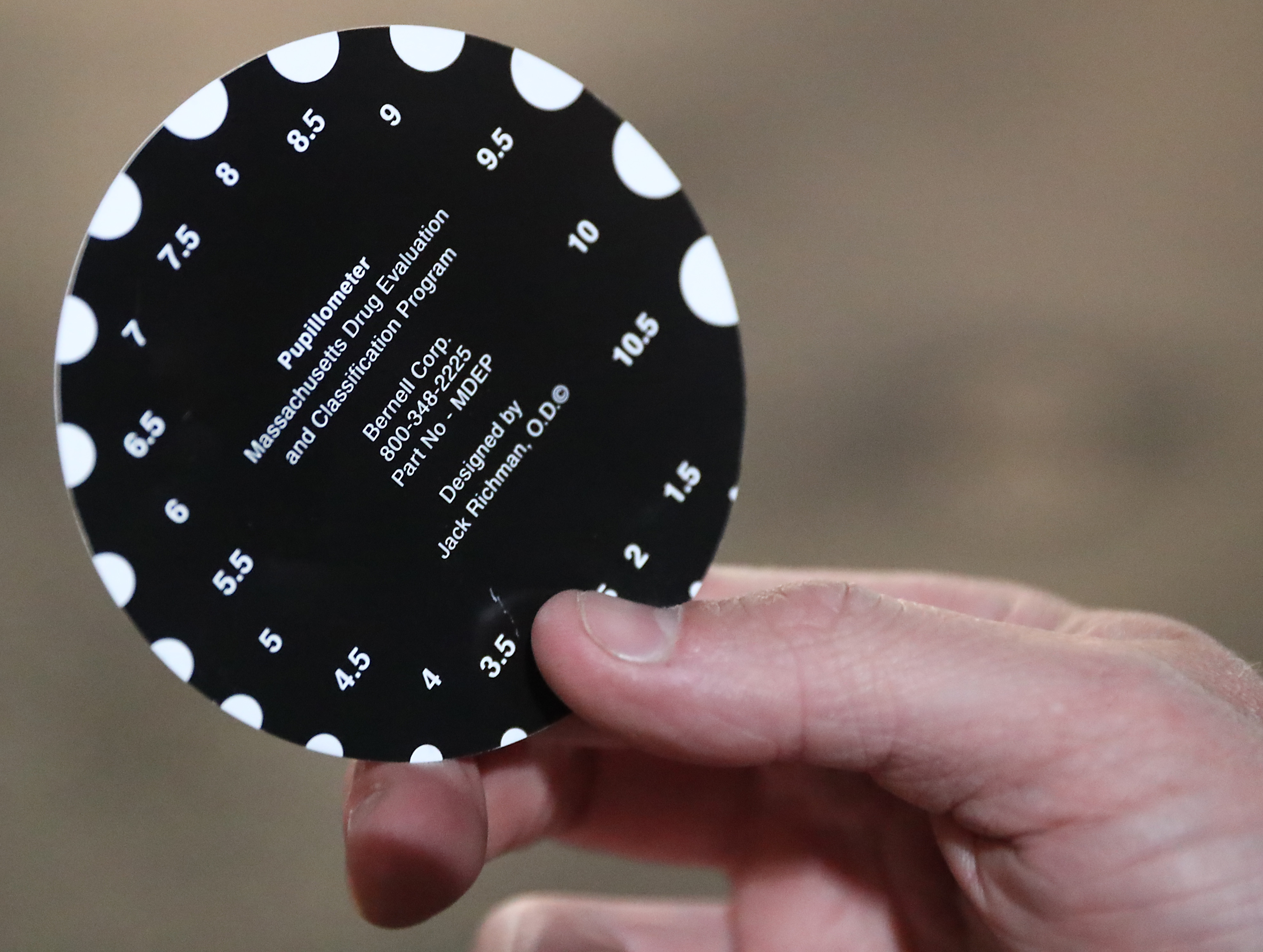 Marchese held a device used to judge pupil size.