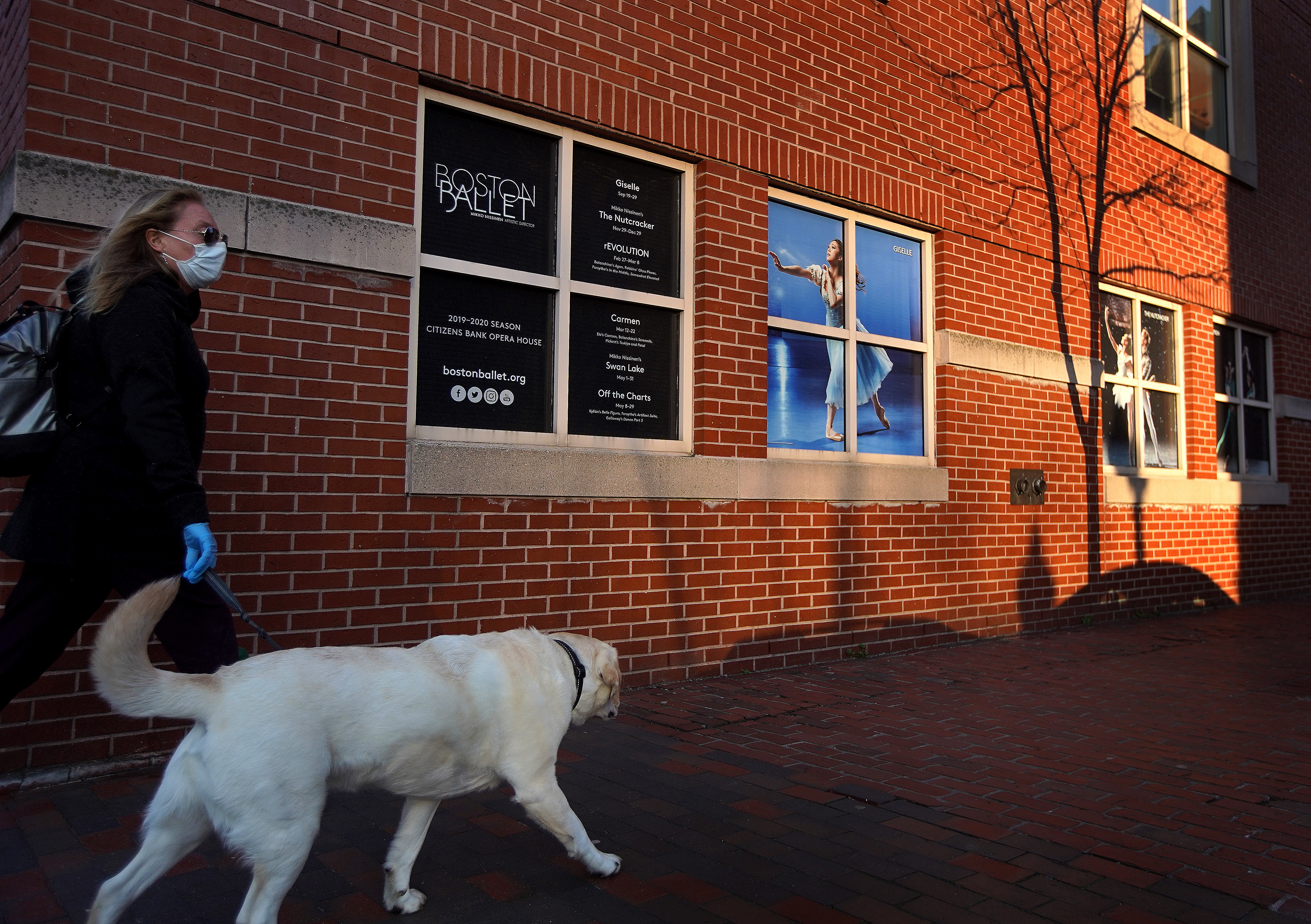 A dog walker passed Boston Ballet's South End headquarters. The organization will furlough its employees in waves through July 27.