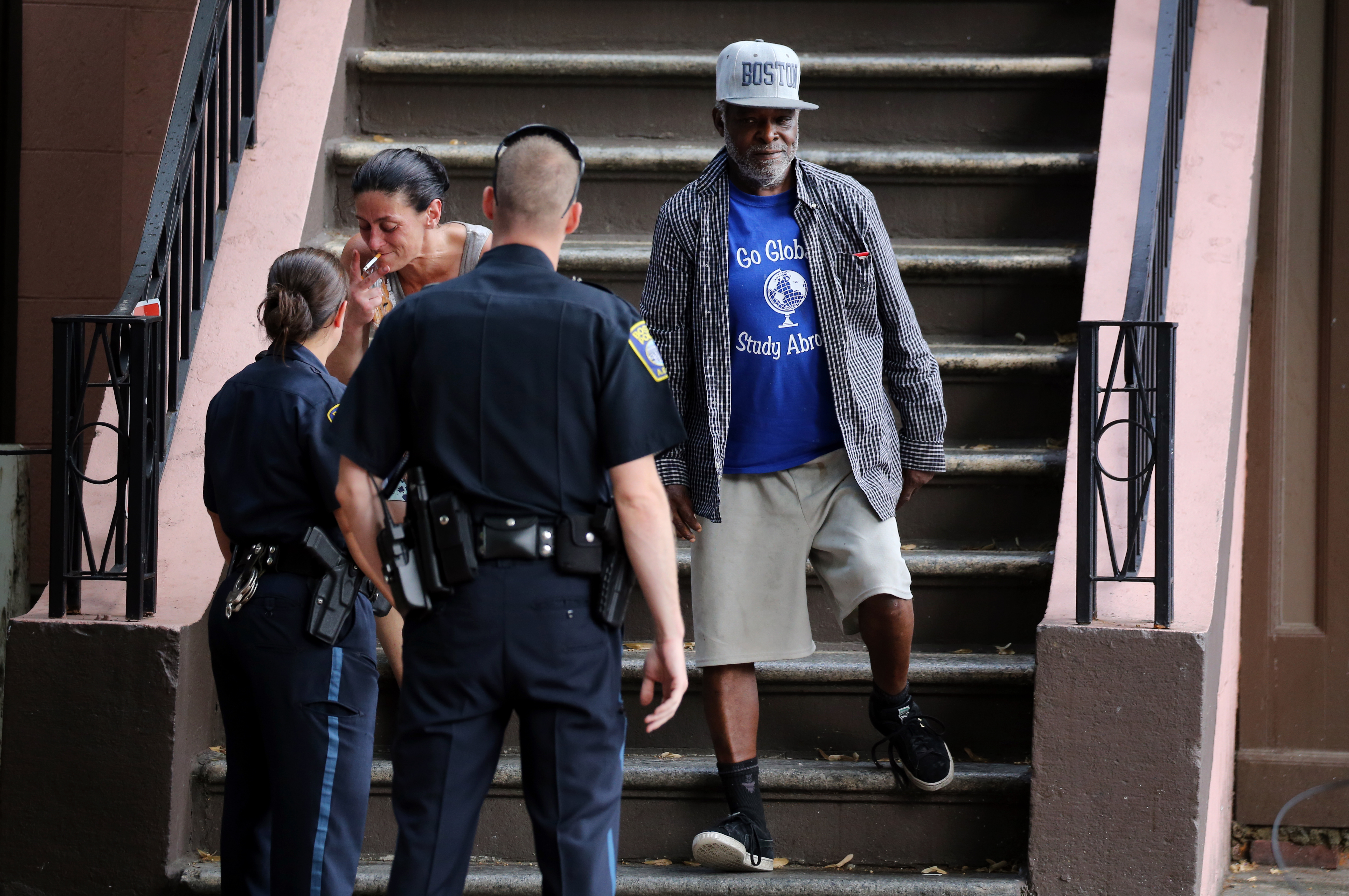 Police officers asked people to not loiter on steps of a home in Worcester Square.