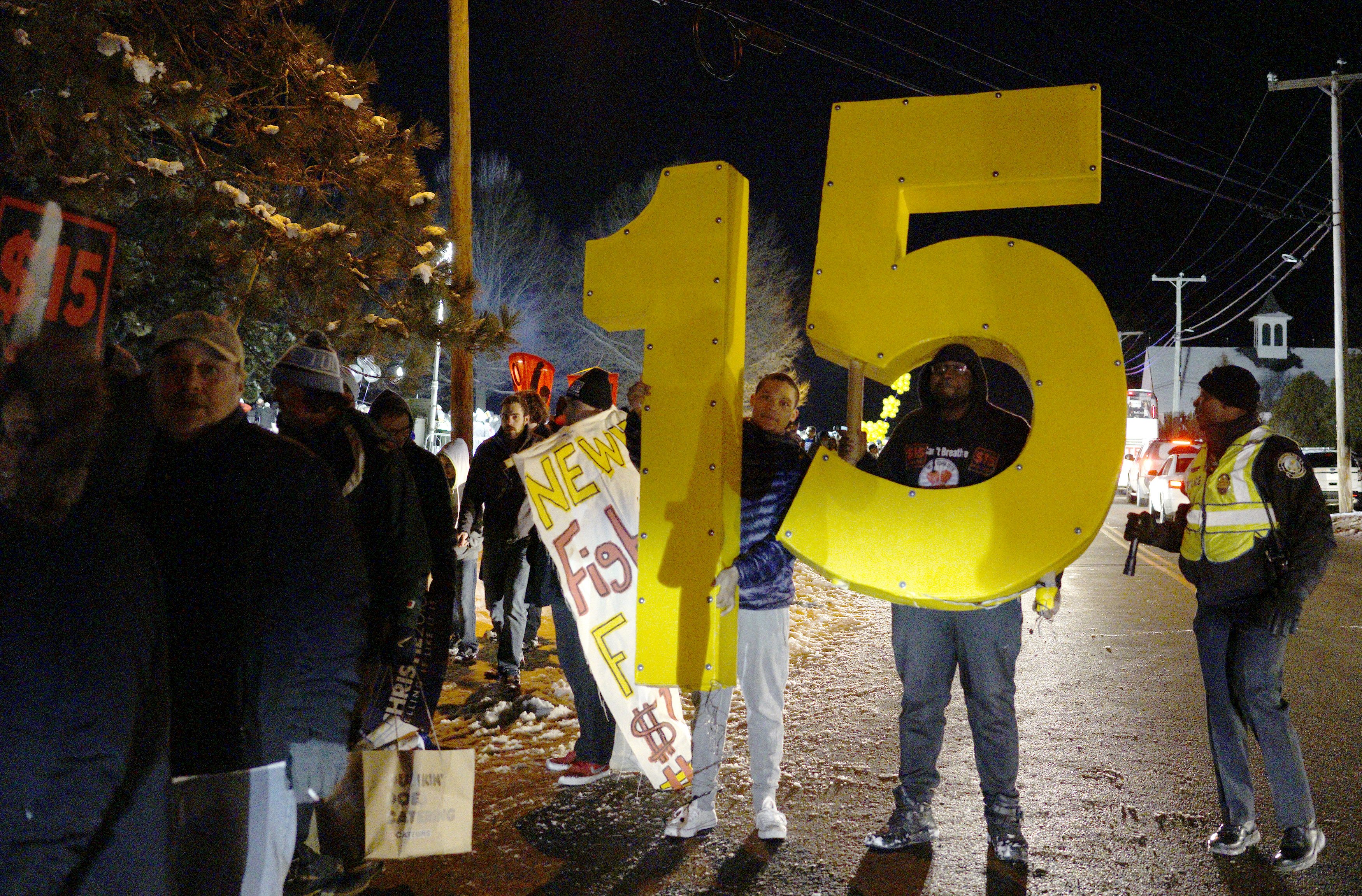 Protesters advocated for a $15-per-hour national minimum wage march outside the Republican presidential debate site in Manchester, New Hampshire last month.