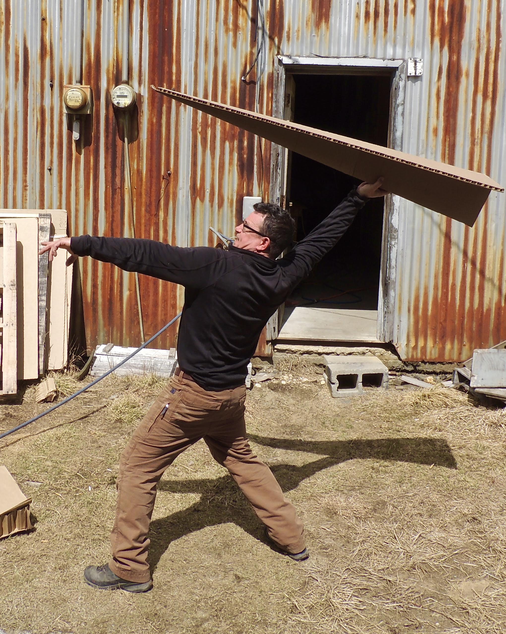Artist Jack Welch tested a cardboard airplane at Fitchburg Municipal Airport.