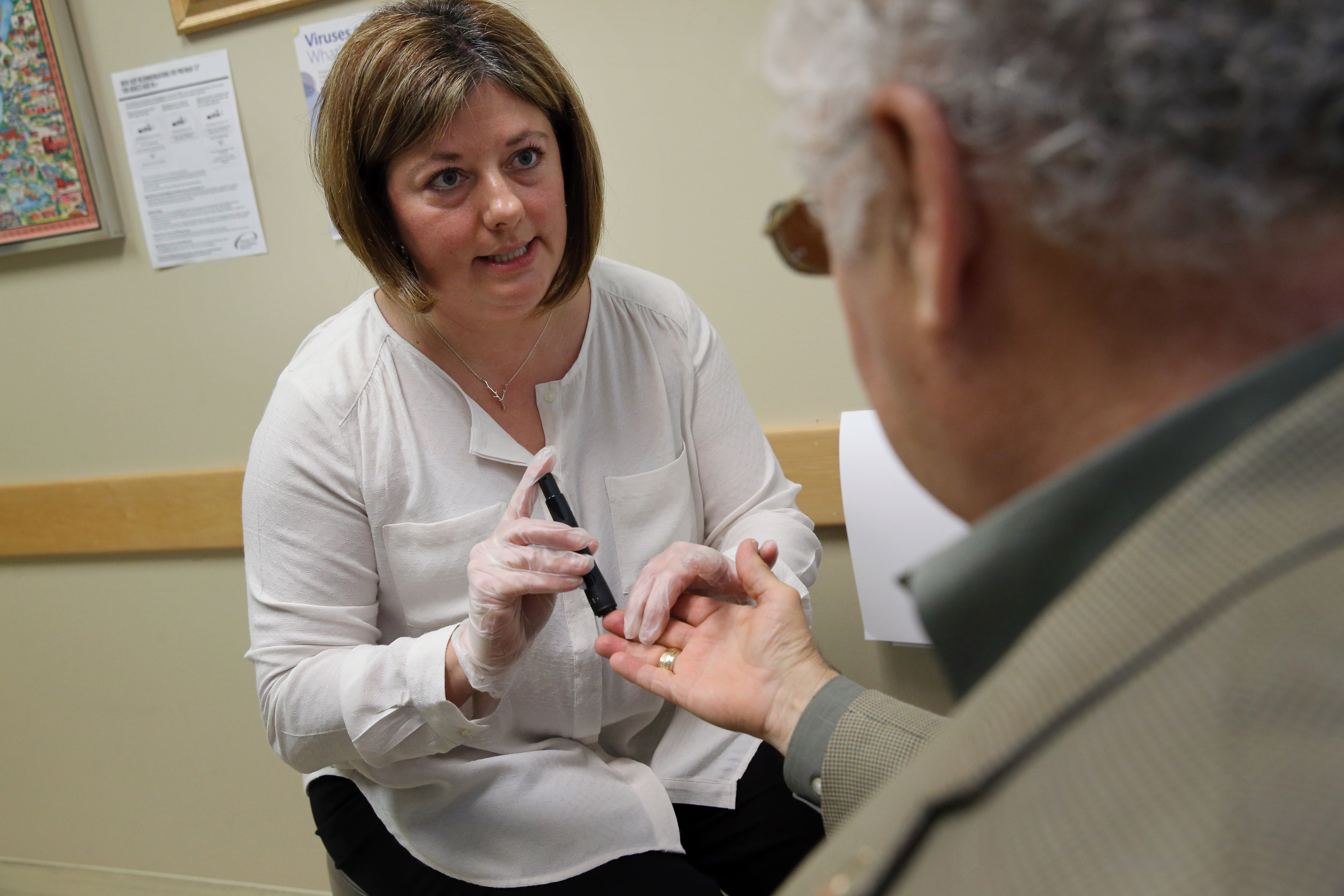 Clinical pharmacist Susan Plante took a blood sample from diabetes patient Ray D’Abate and taught him how to use a glucometer at Coastal Medical in East Providence.