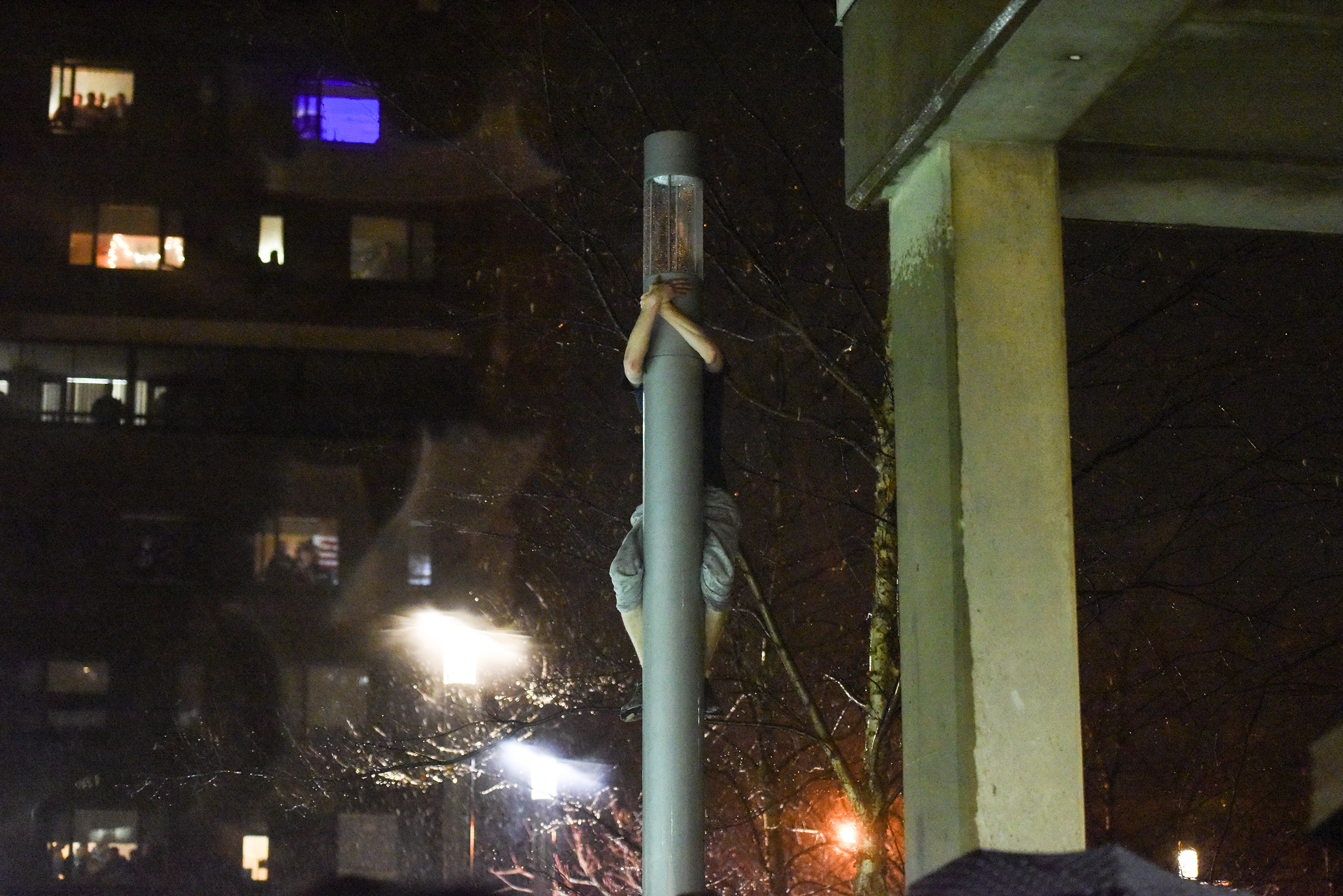 A person climbed a pole at UMass Amherst.