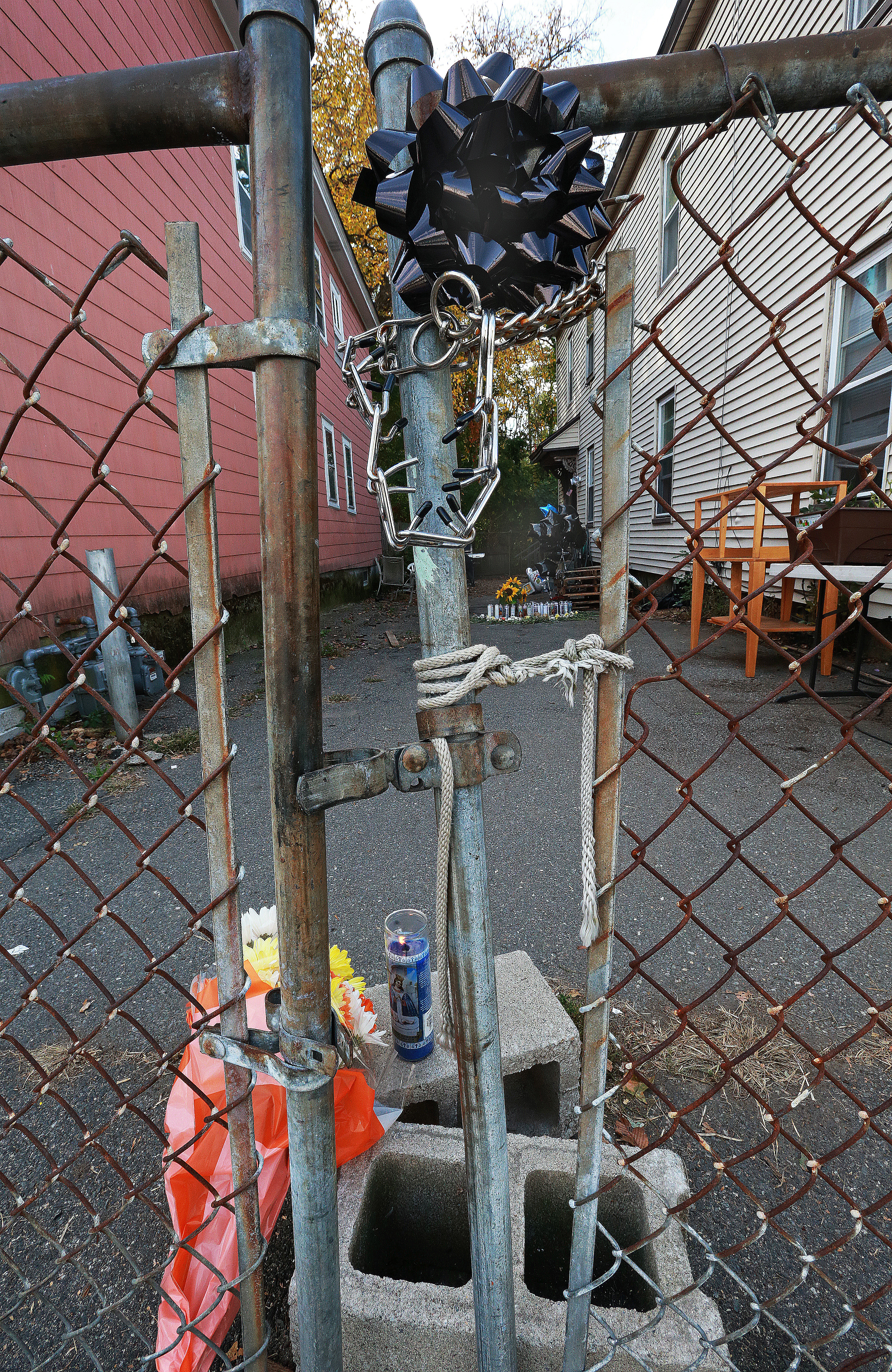Flowers, candles, and a black ribbon marked the scene where Javian Candolario was mauled to death in Lowell.