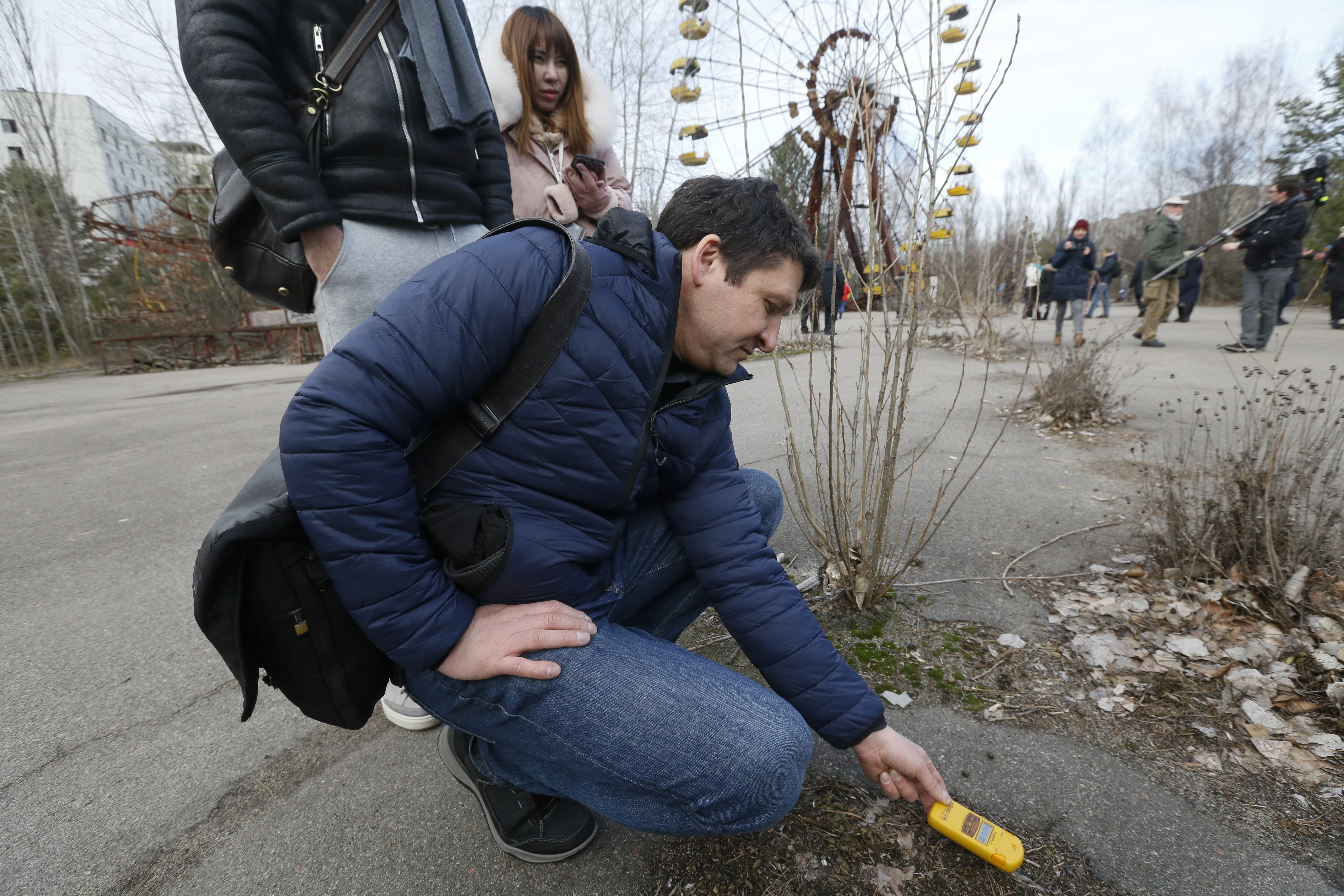 A tourist measures radiation level in the deserted town of Pripyat, near the Chernobyl nuclear power plant in Ukraine, earlier this month.