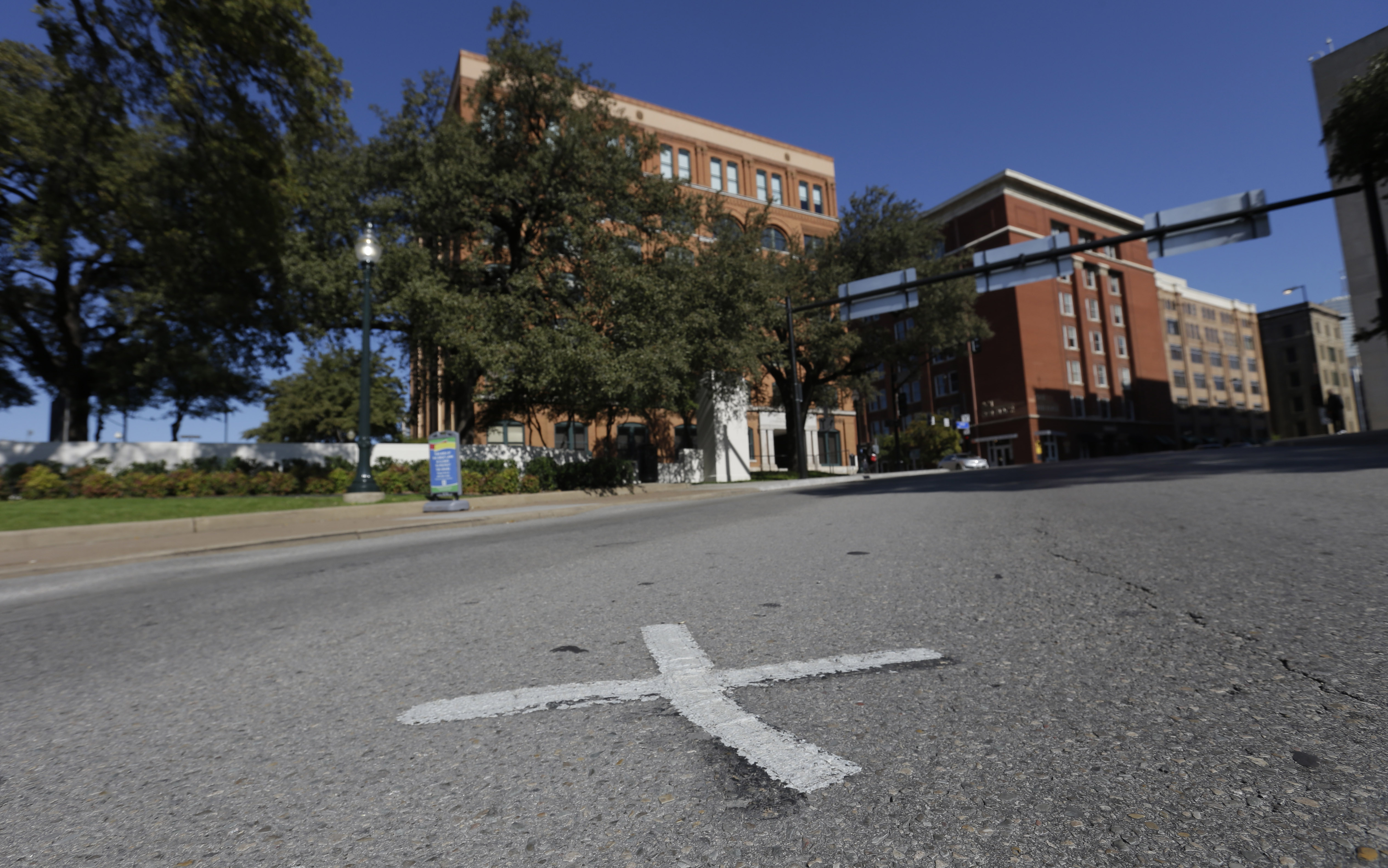 Self-styled “assassination researchers” periodically mark the spots where bullets struck the president, but the city removes the markings, only to find them repainted once again.