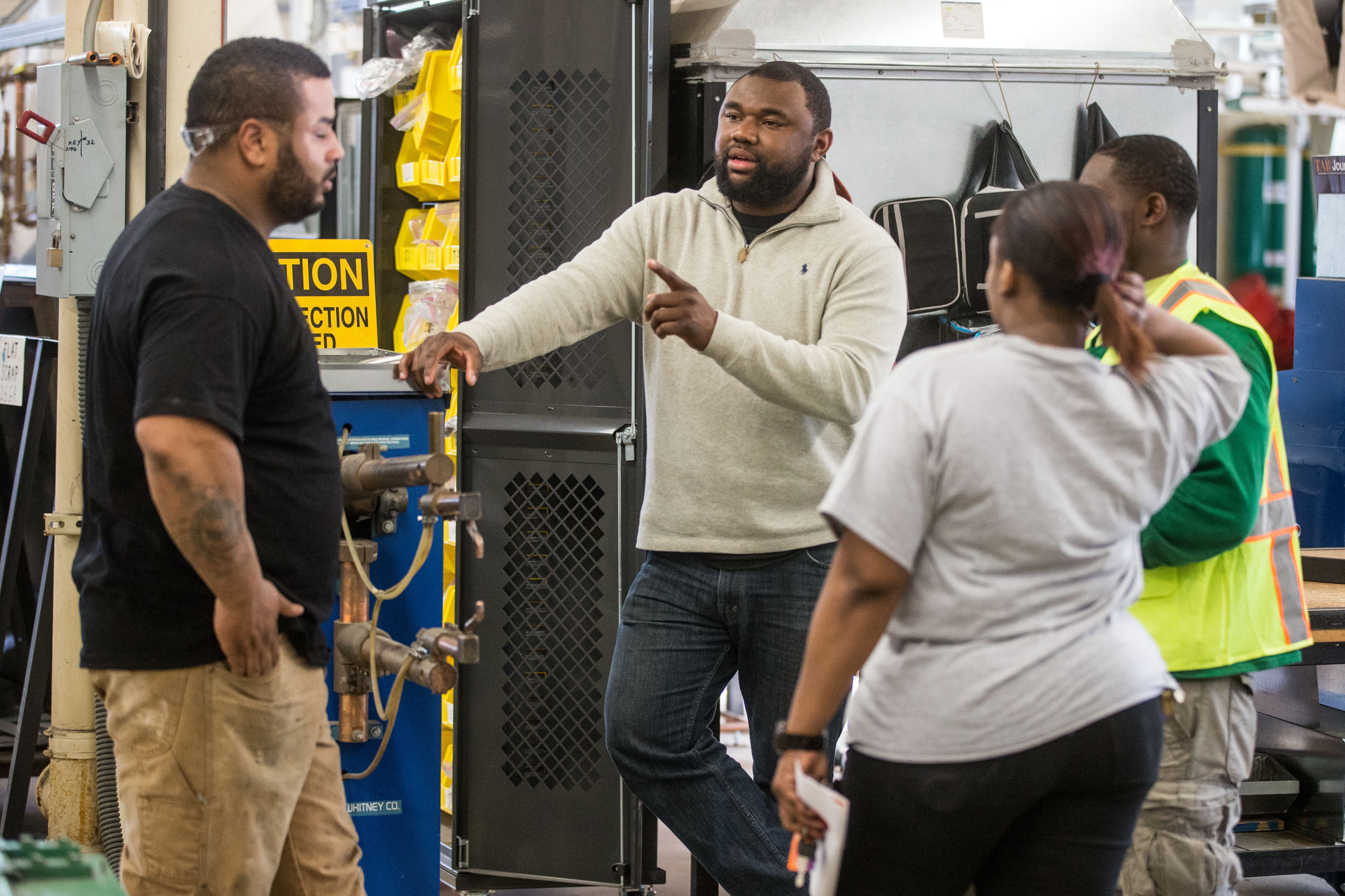 Project Coordinator Tyrone Kindell Jr. (center) spoke with Building Pathways participants Jonathan Rivera, Tabia Gustave, and Demetrius Aaron.