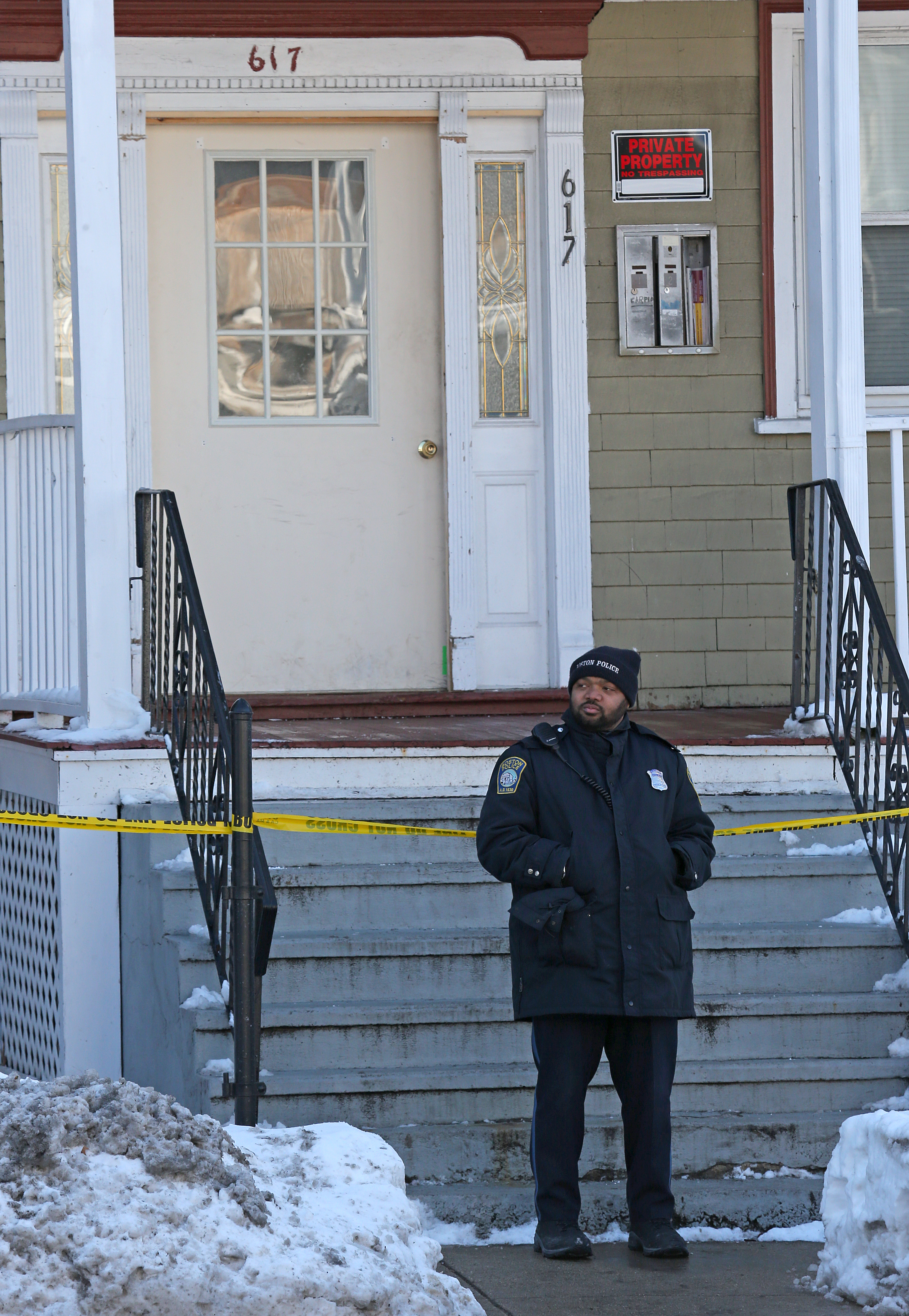 Police investigated the fatal shooting of a boy at the three-decker on Morton Street in Mattapan.