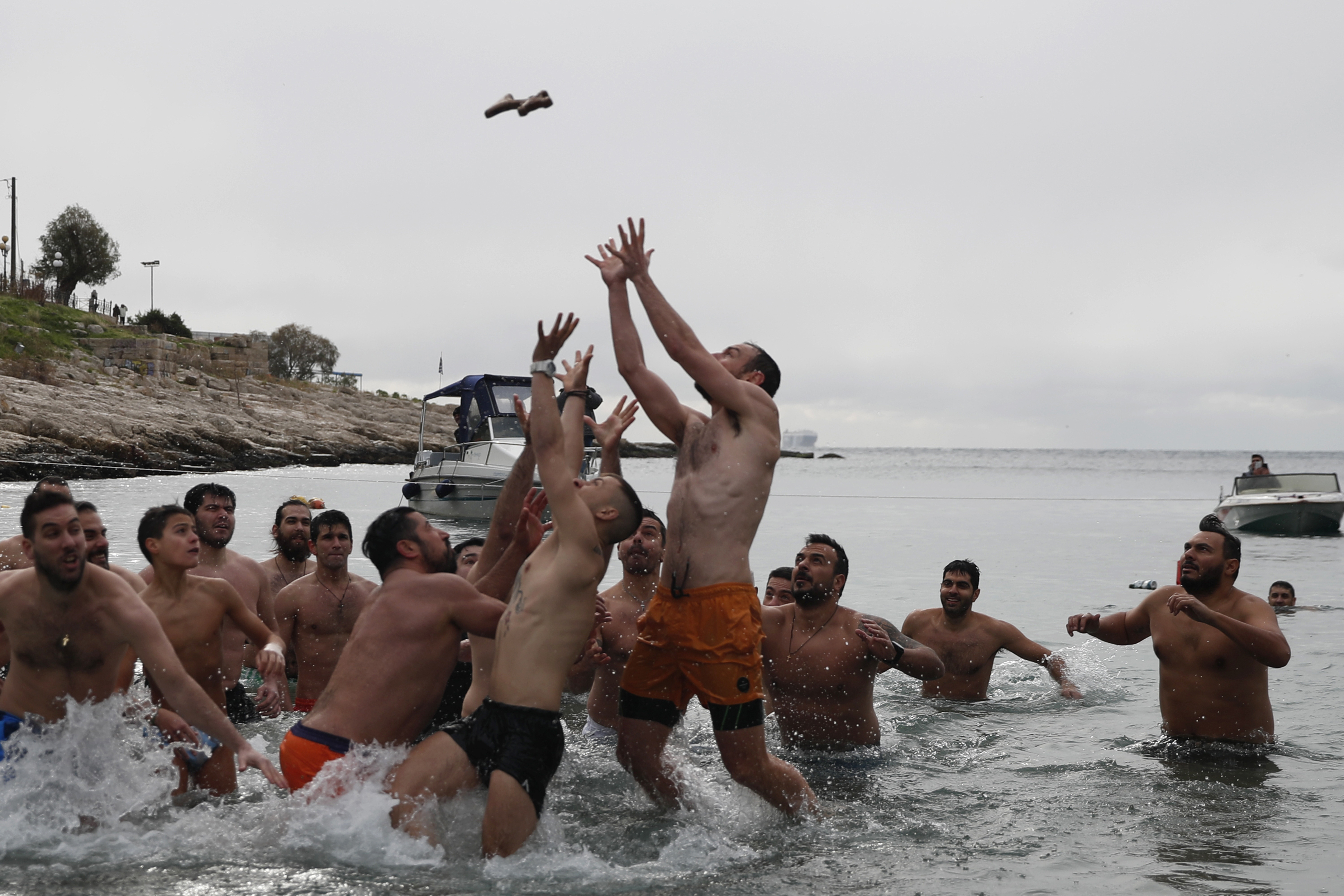 Swimmers jumped to catch the cross during a ceremony near Athens, Greece.