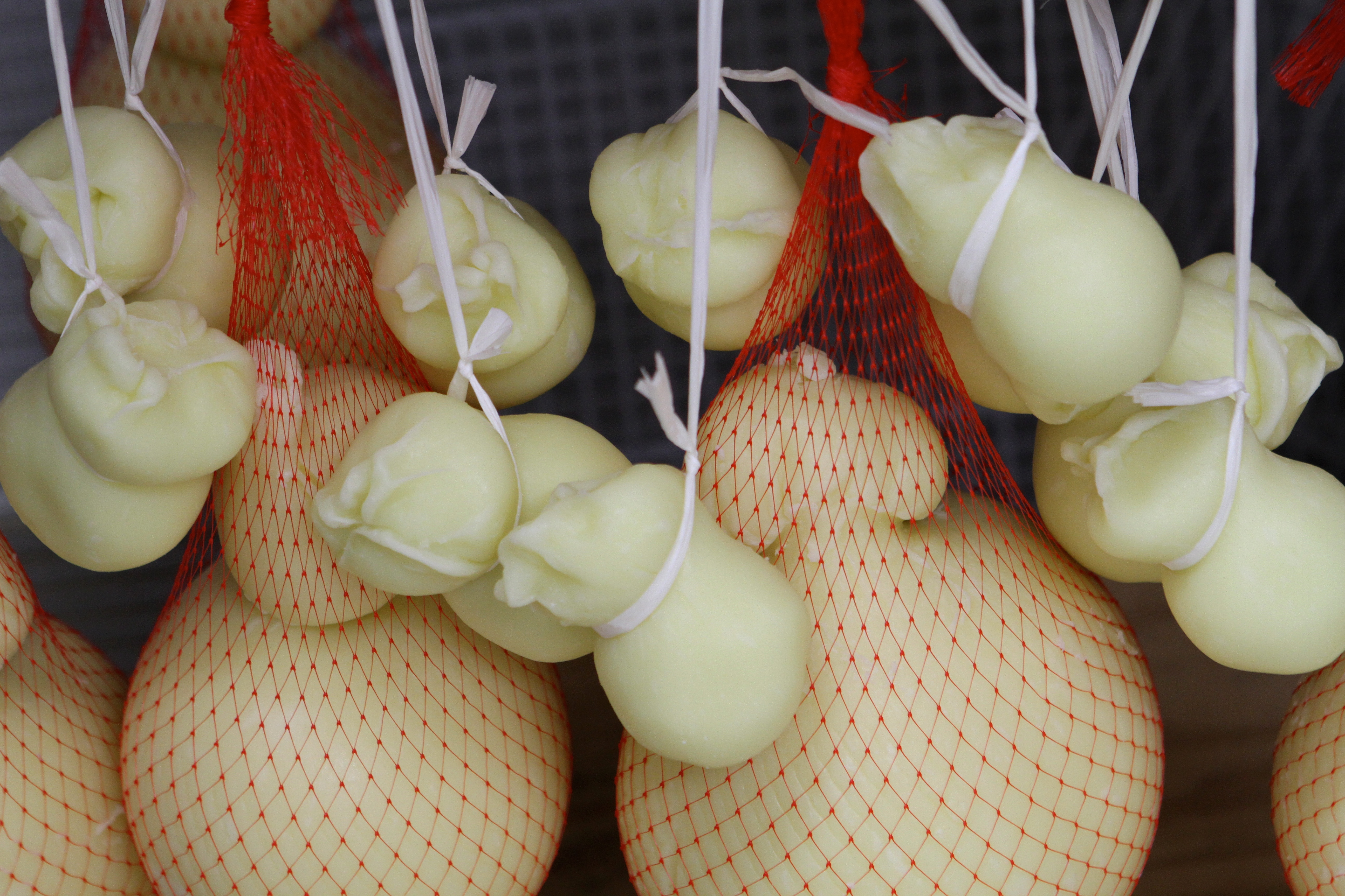 Caciocavallo hangs in the aging room.