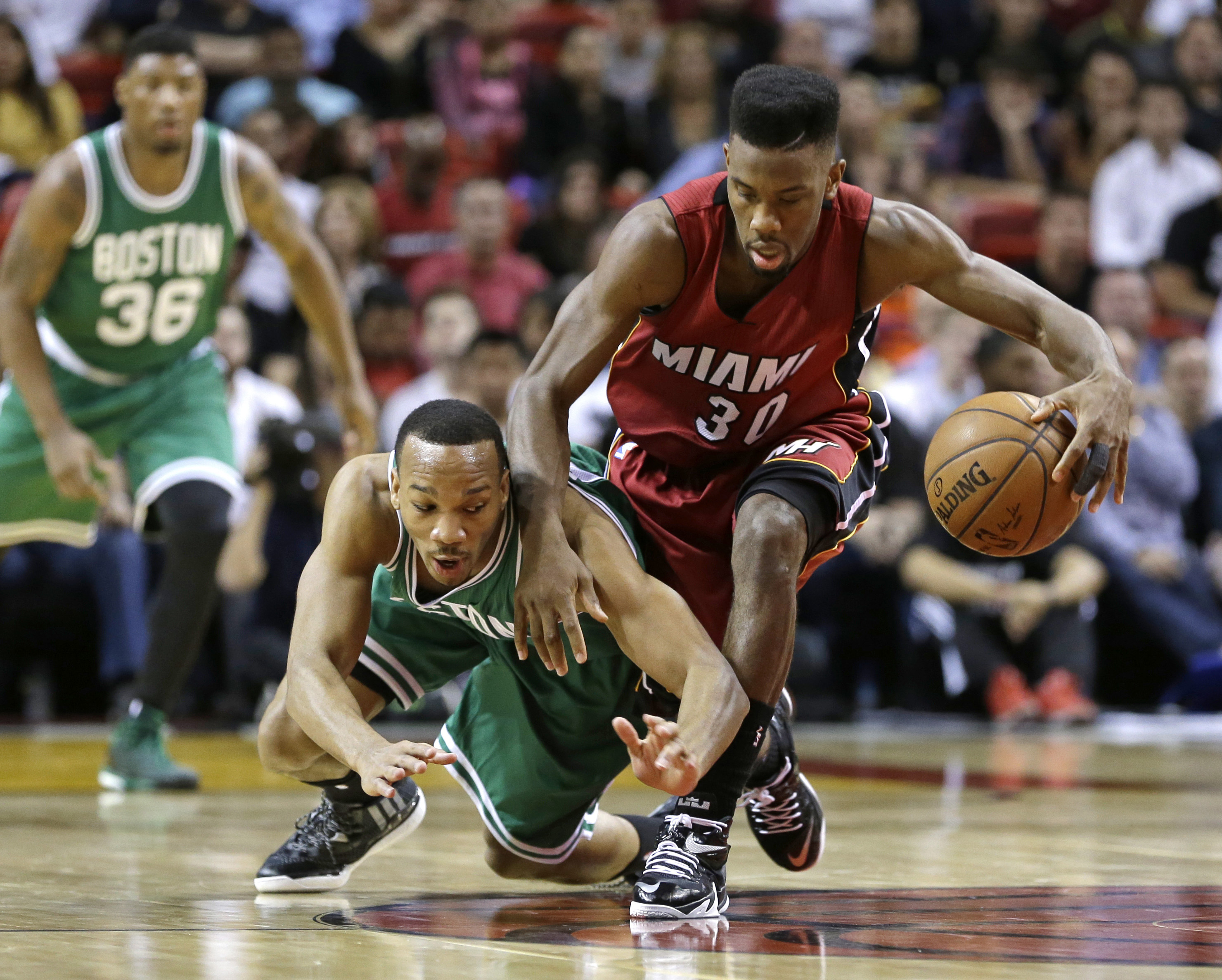 Miami Heat guard Norris Cole recovered a loose ball against Celtics guard Avery Bradley.