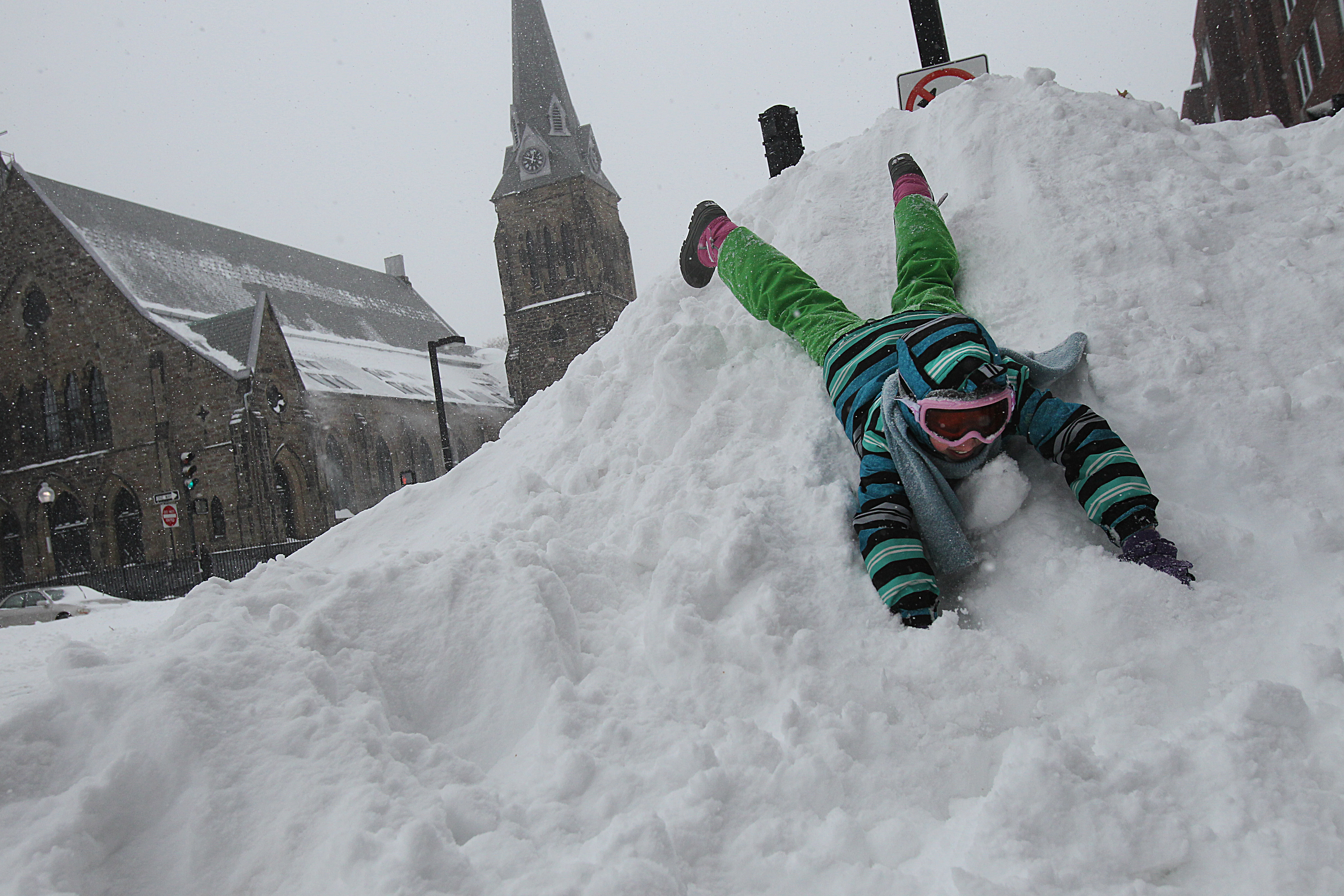 Amy Grace, 10, played on a snow mountain on Tremont Street in the South End Tuesday. A lot of people found the much-hyped storm easy to handle and got out to enjoy it.