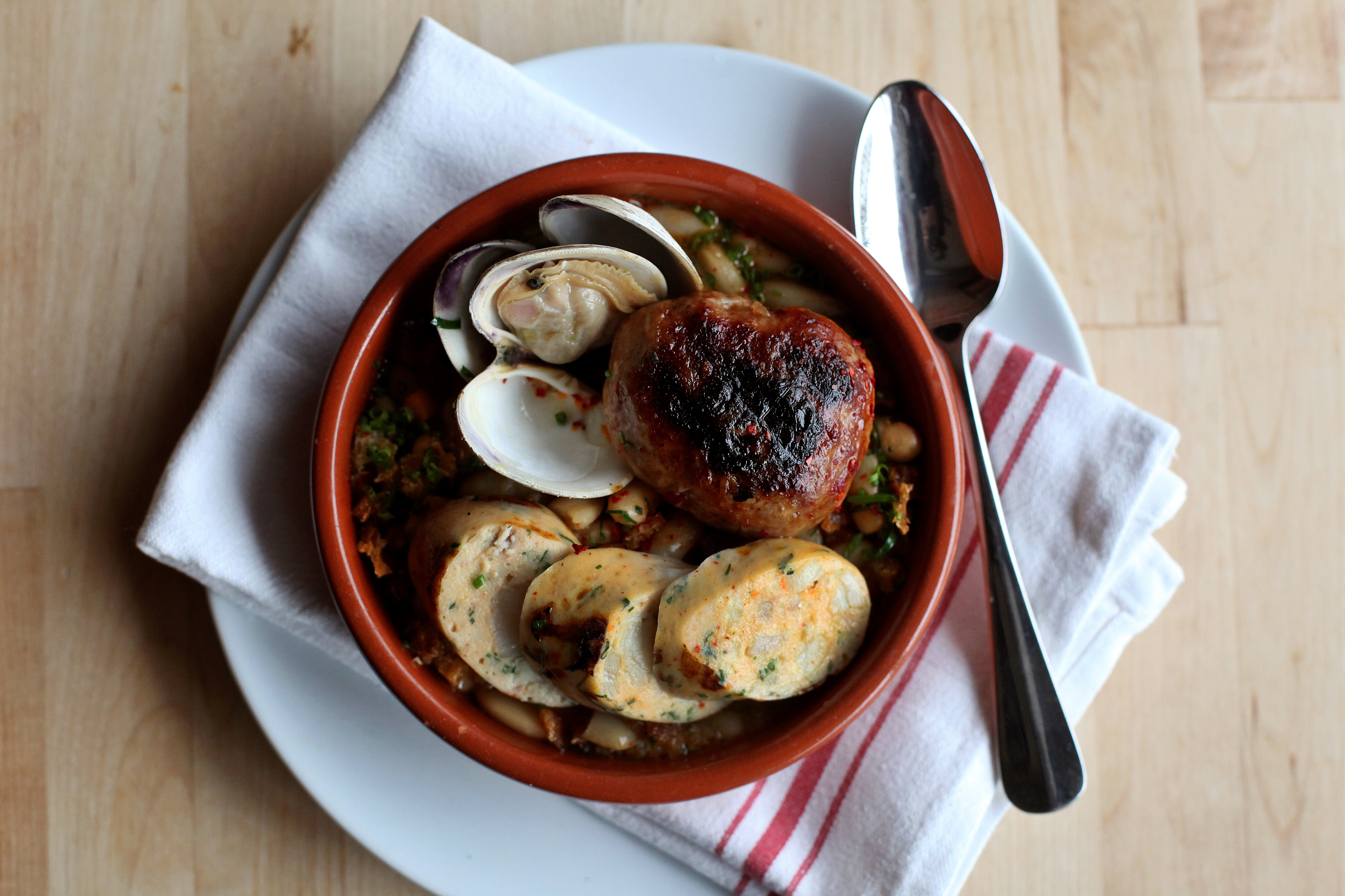 In Newton, Sycamore’s Spanish seafood cassoulet with housemade chorizo, fish sausage, and littlenecks.