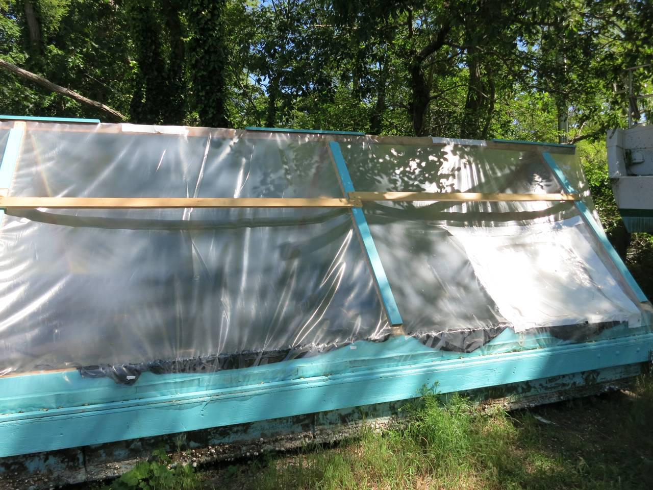 The wood-framed greenhouses.