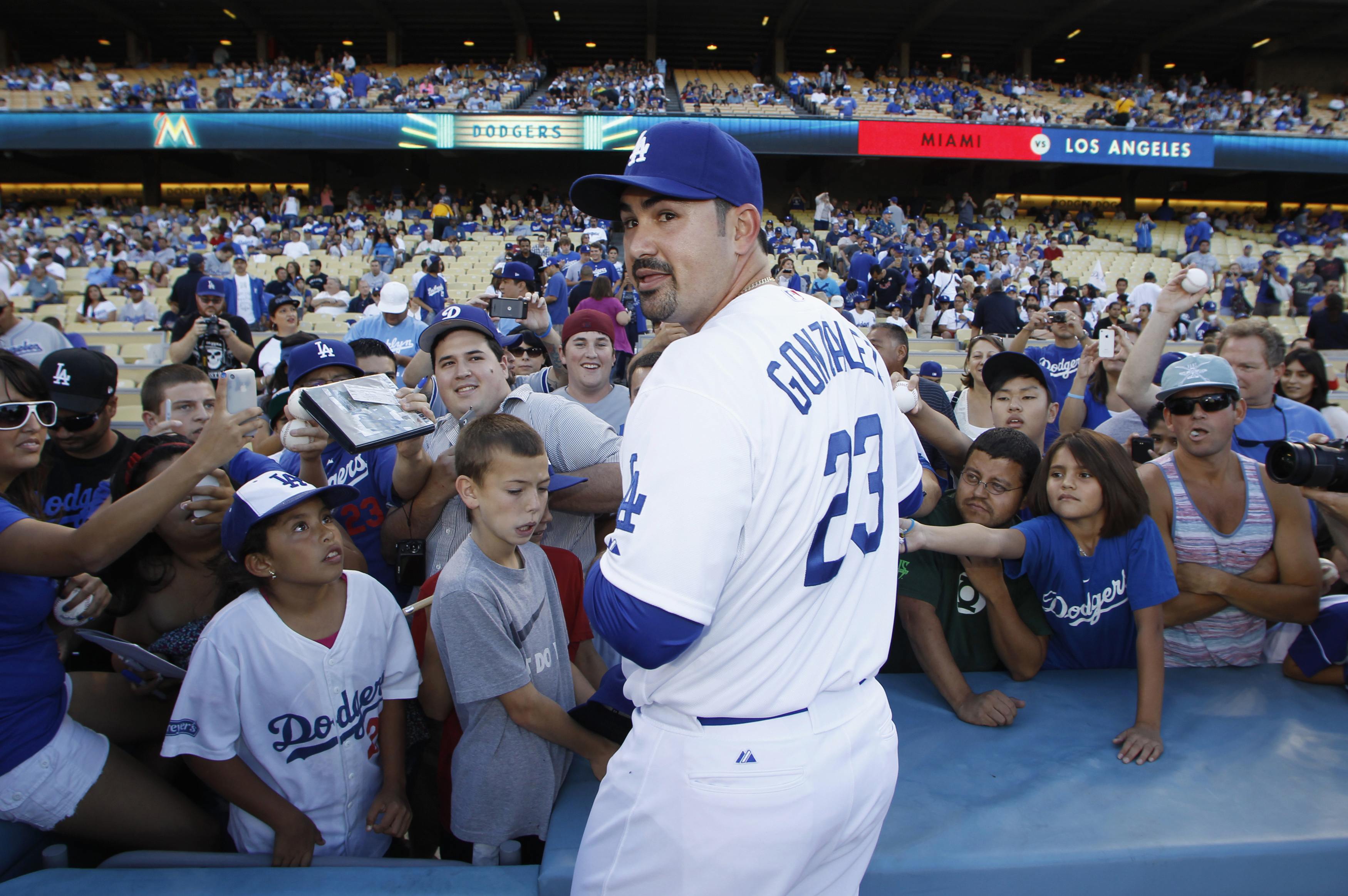 Back in California, Adrian Gonzalez signed autographs Saturday prior to the start of his first game with the Los Angeles Dodgers.