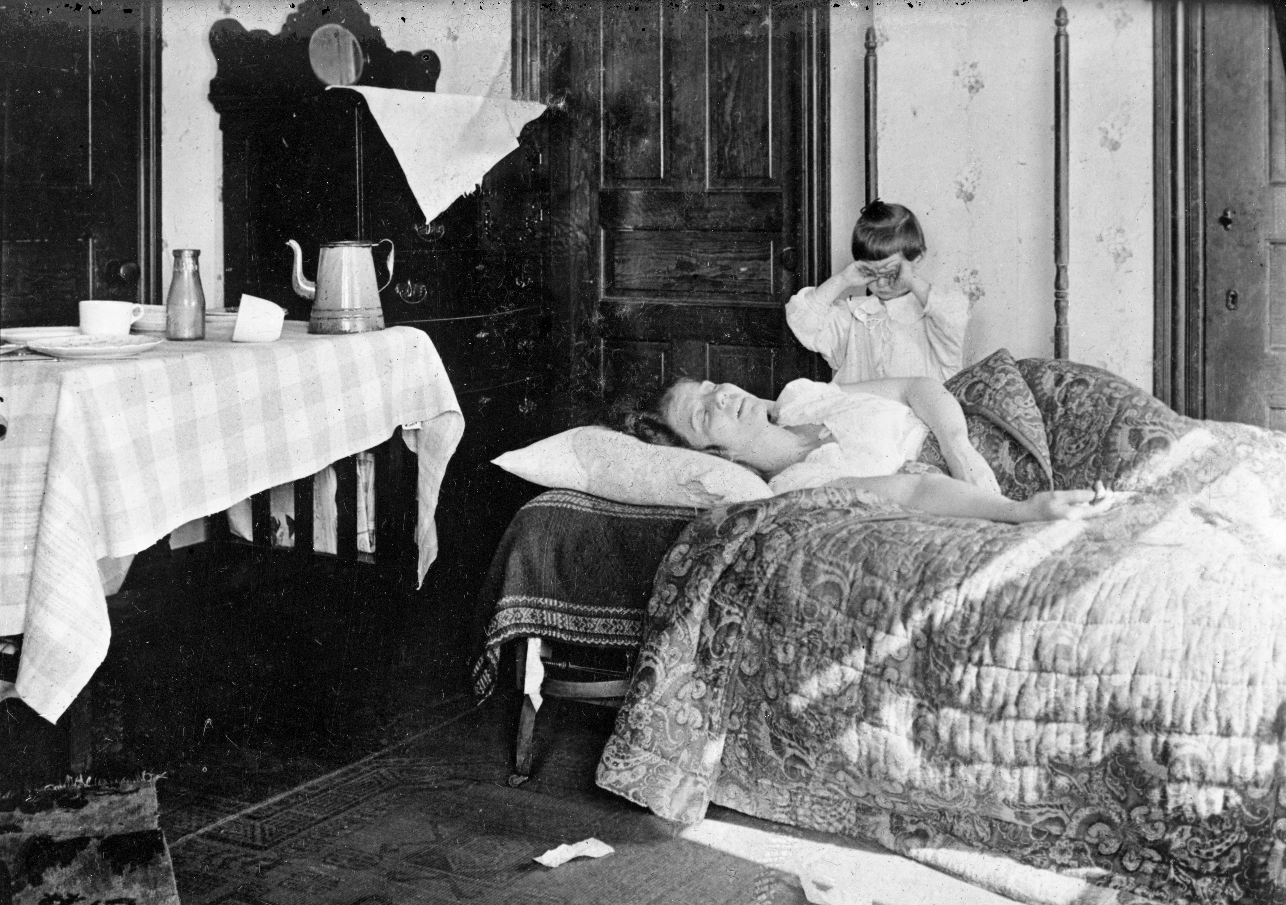 The flu outbreak spread from Boston, becoming a pandemic that killed an estimated 50 million people around the world, sometimes wiping out entire families. Here, a distraught girl stands beside her ailing sister.