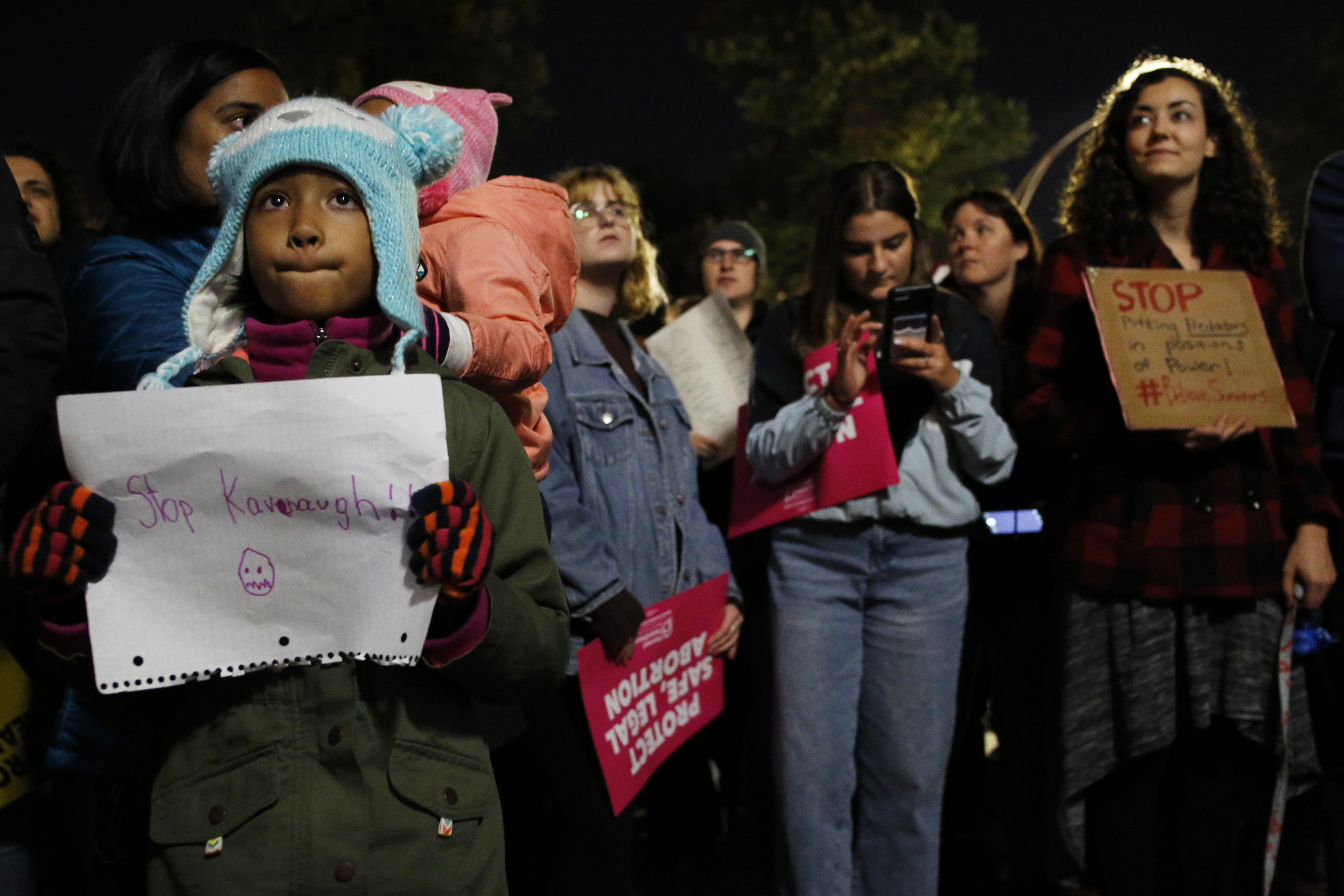 Aasiyah Ricaurte, 8, held a sign outside of the State House.