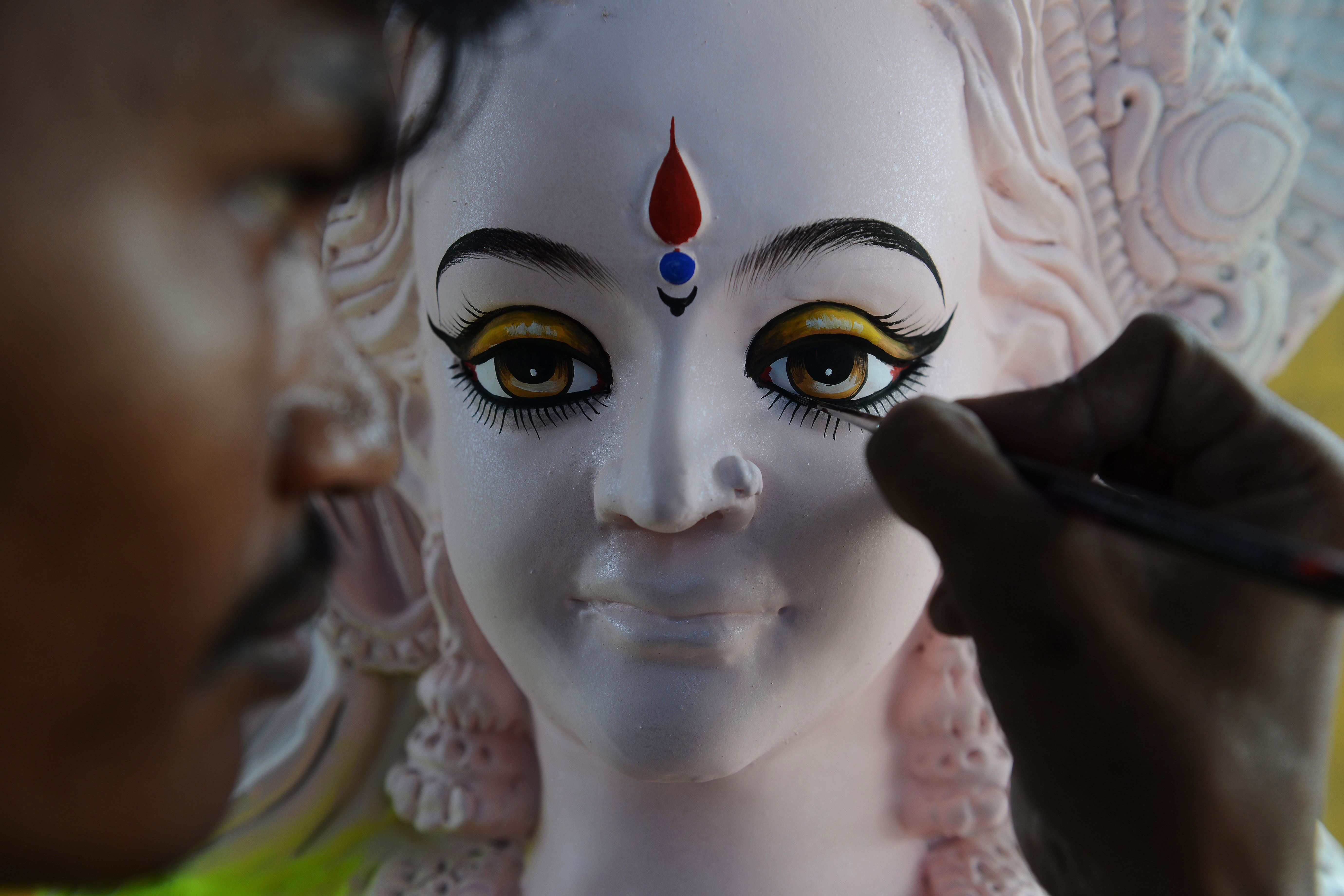 An artist applied finishing touches to a statue of the Hindu goddess Durga ahead of the Dushhera-Vijaya Dashami festival.