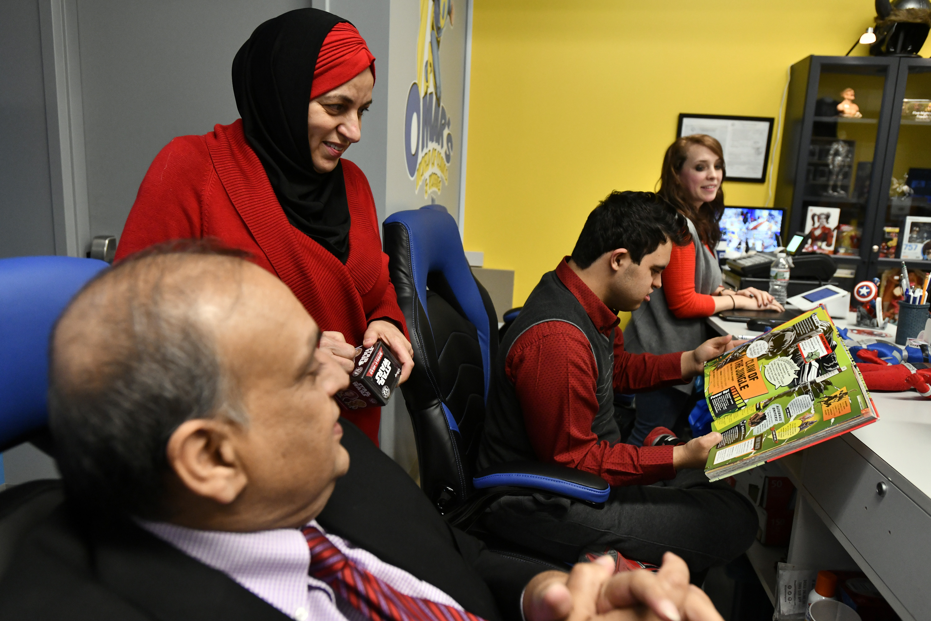 Sohail and Mona Masood with their son, Omar, and store manager Sally Hoops.