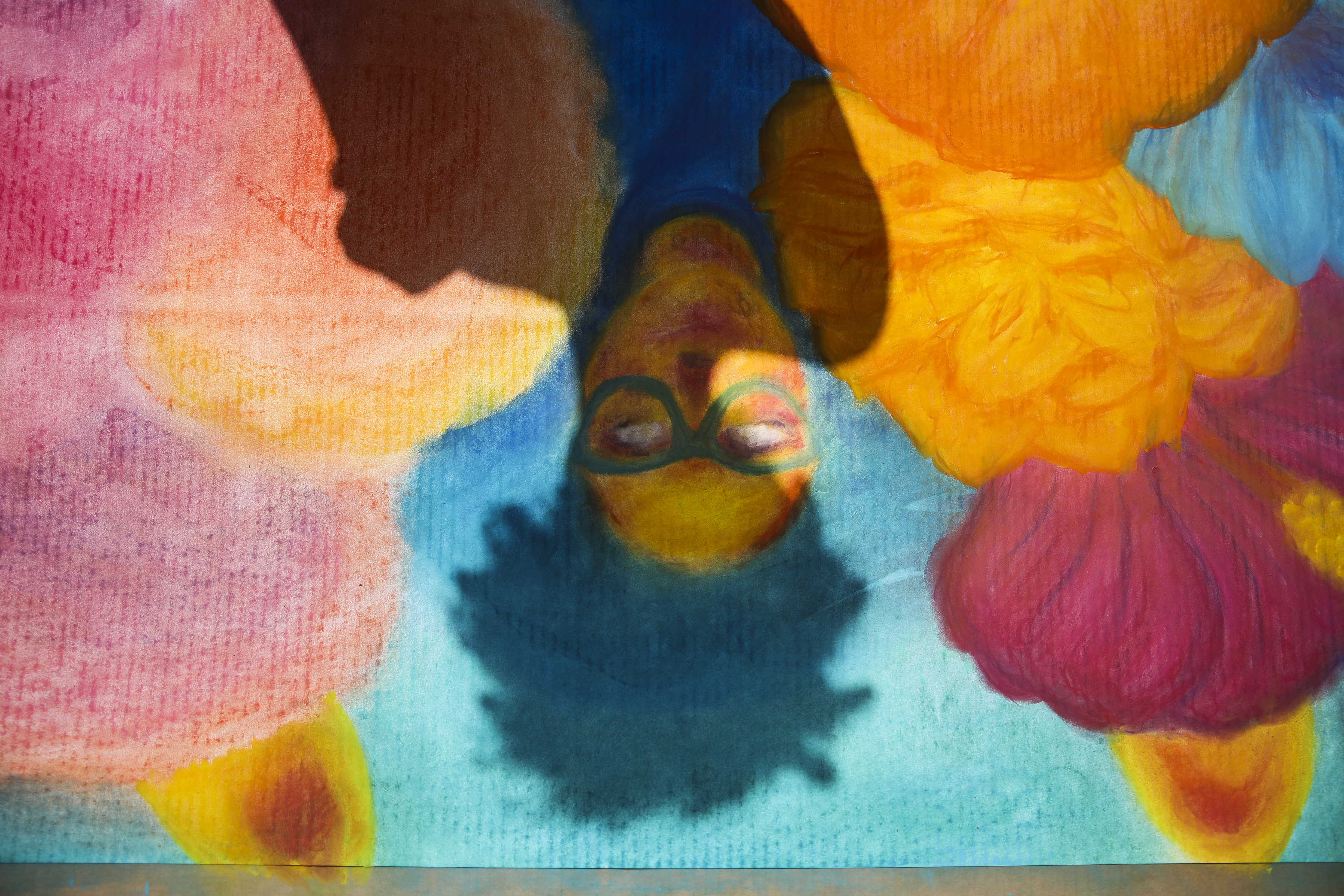 The shadow of Mariluz Rodriguez was cast upon her chalk mural in downtown Hazleton.