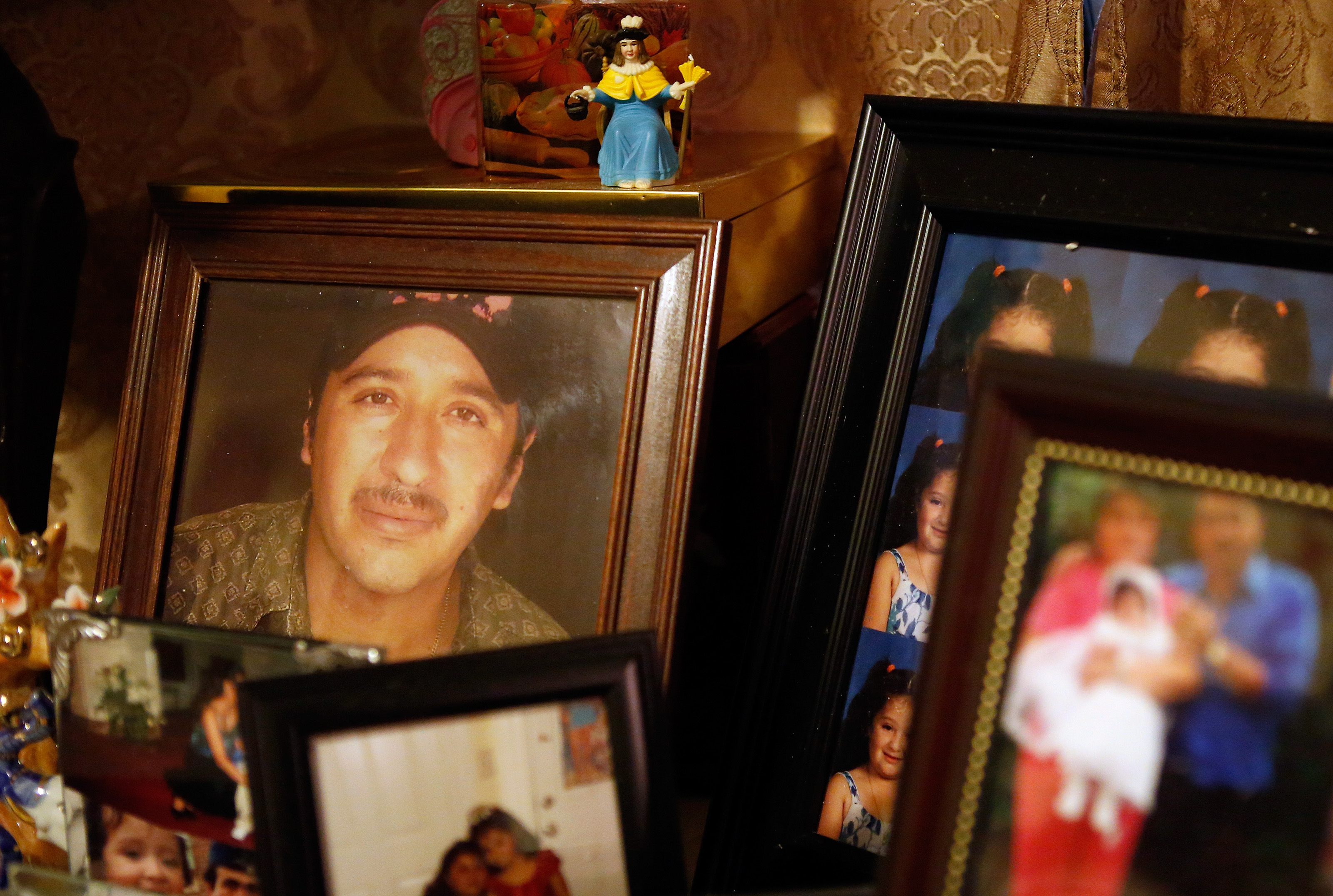 A photo of Santos Interiano sat among other family photographs on a table in the East Boston home of his sister Maria.
