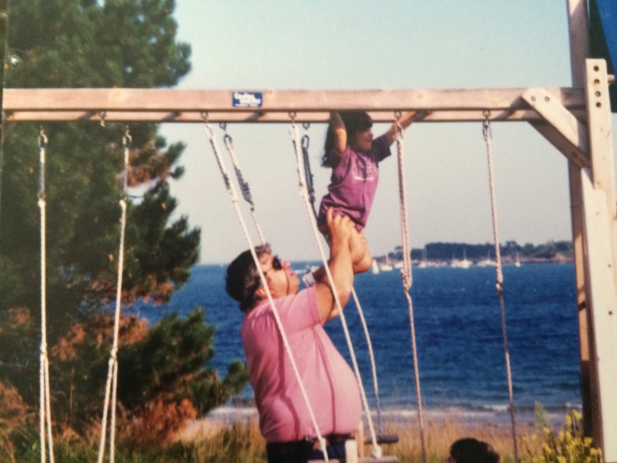 Evan Wile helping one of his daughters navigate the monkey bars in the mid-1990s.