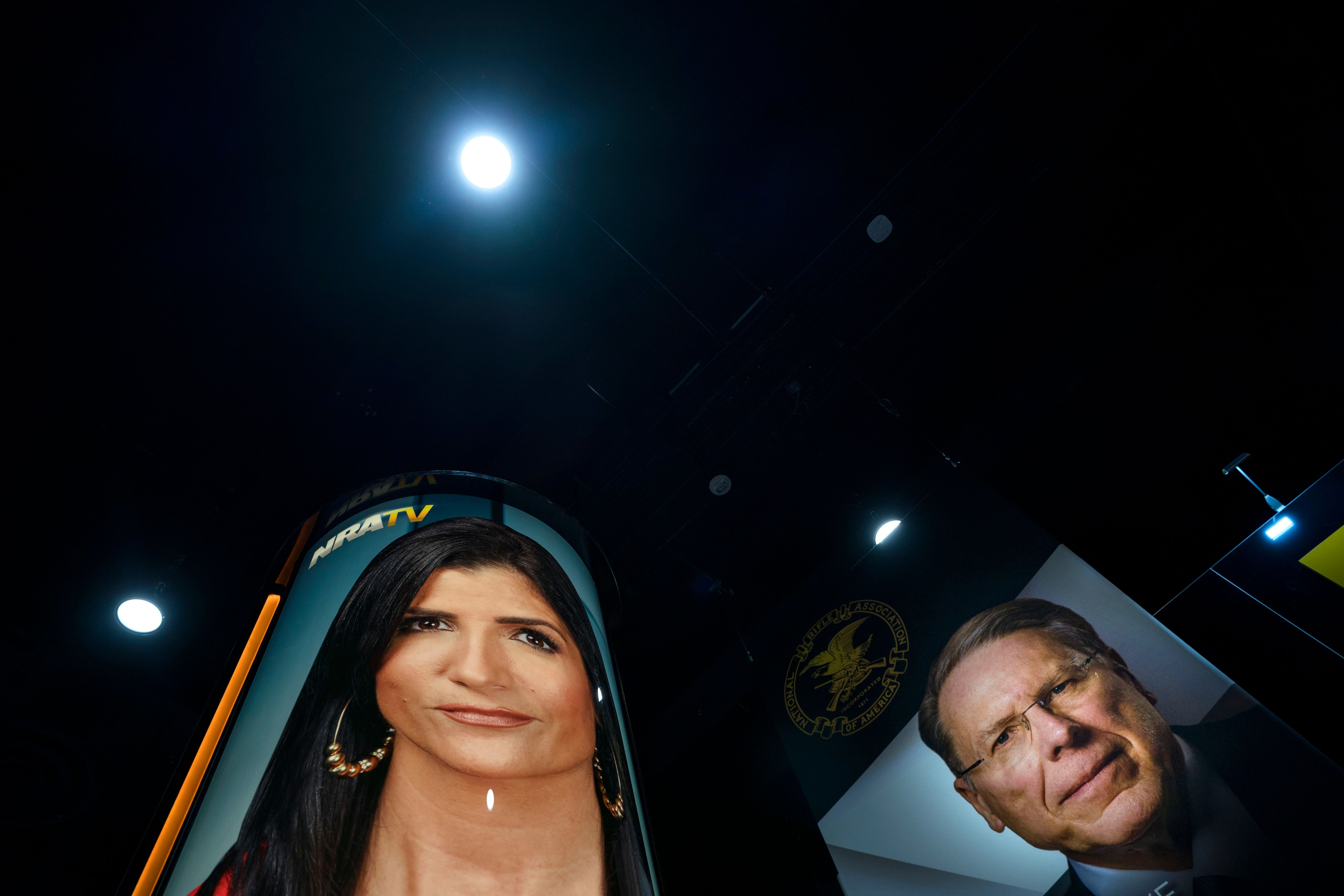 Photographs of NRA spokeswoman Dana Loesch (left) and NRA executive vice president and CEO Wayne LaPierre were posted in the vendors area of the 45th annual Conservative Political Action Conference.