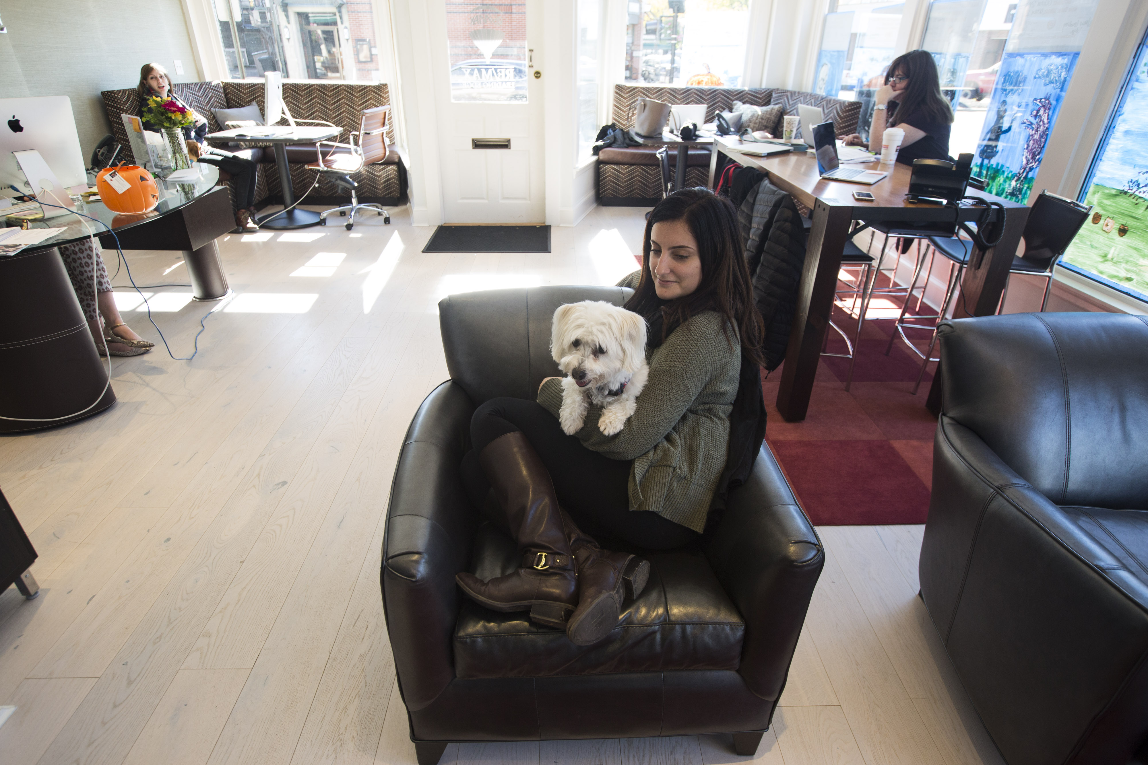 Grace Lima with Molly, a co-worker’s dog at RE/Max Leading Edge.