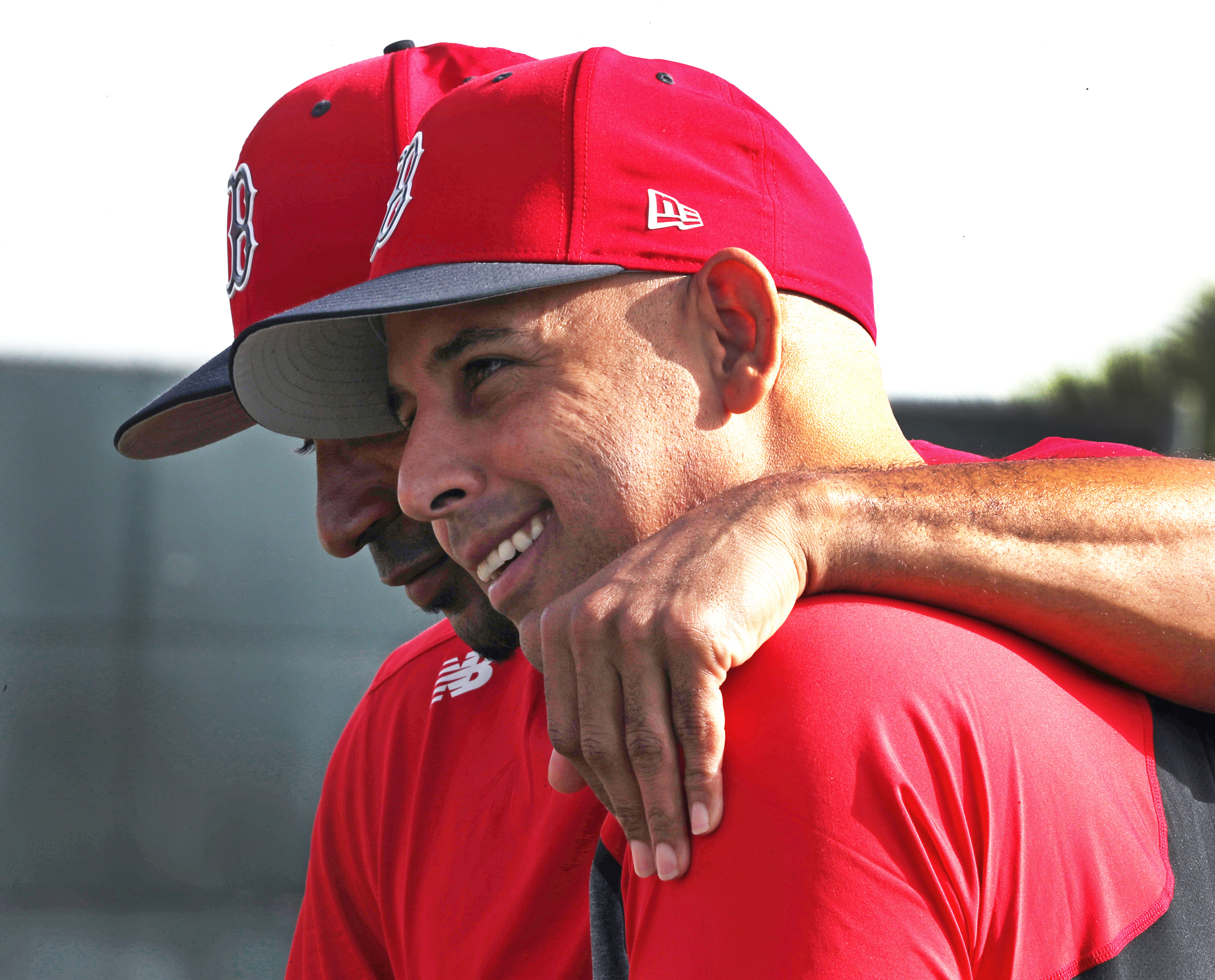 Tom Goodwin (left), sharing a moment with Alex Cora, has leaned on his baseball families during the tough times.