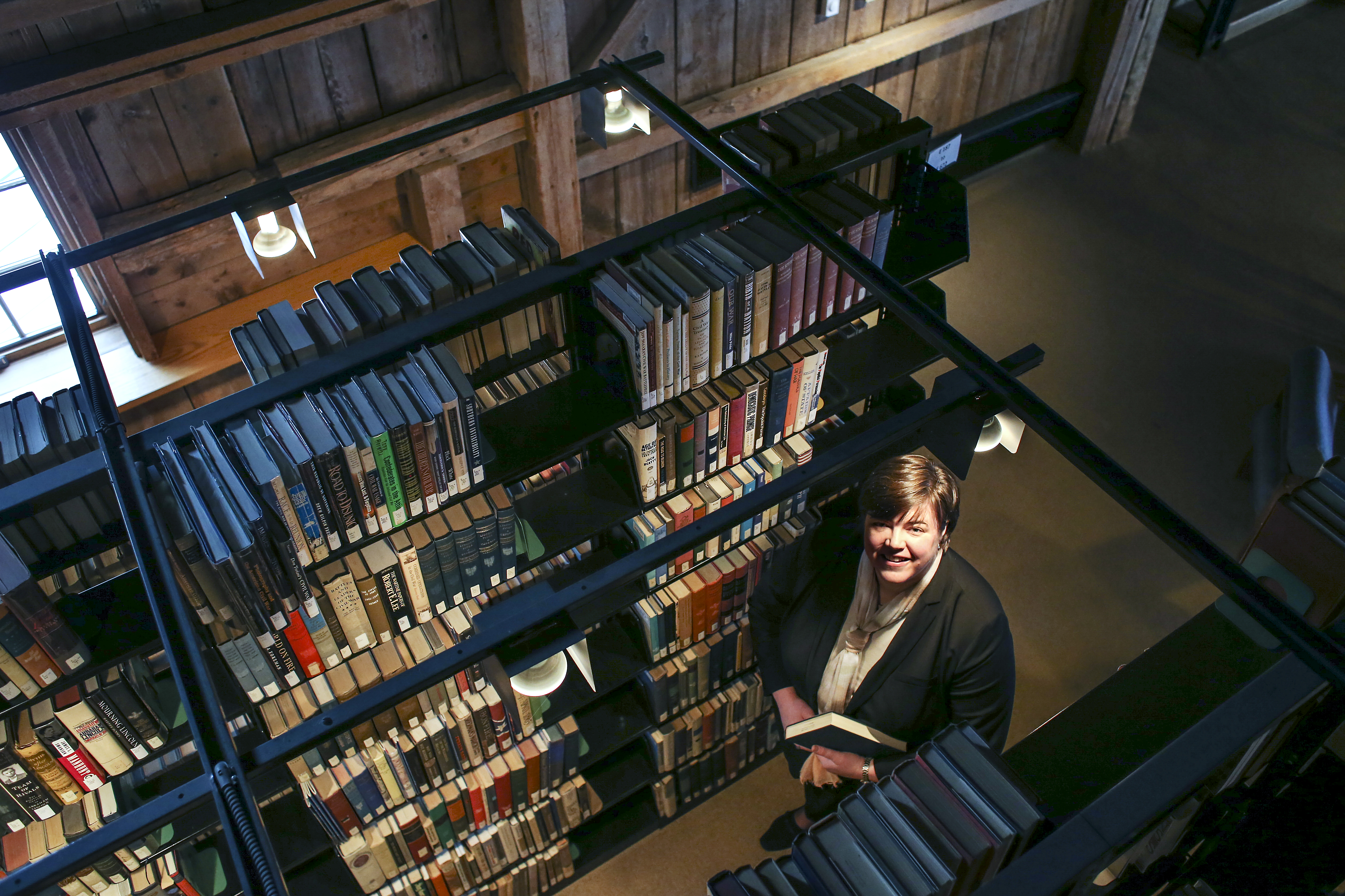 College President Susan Stuebner stood between shelves of books in the campus library on Jan. 10.
