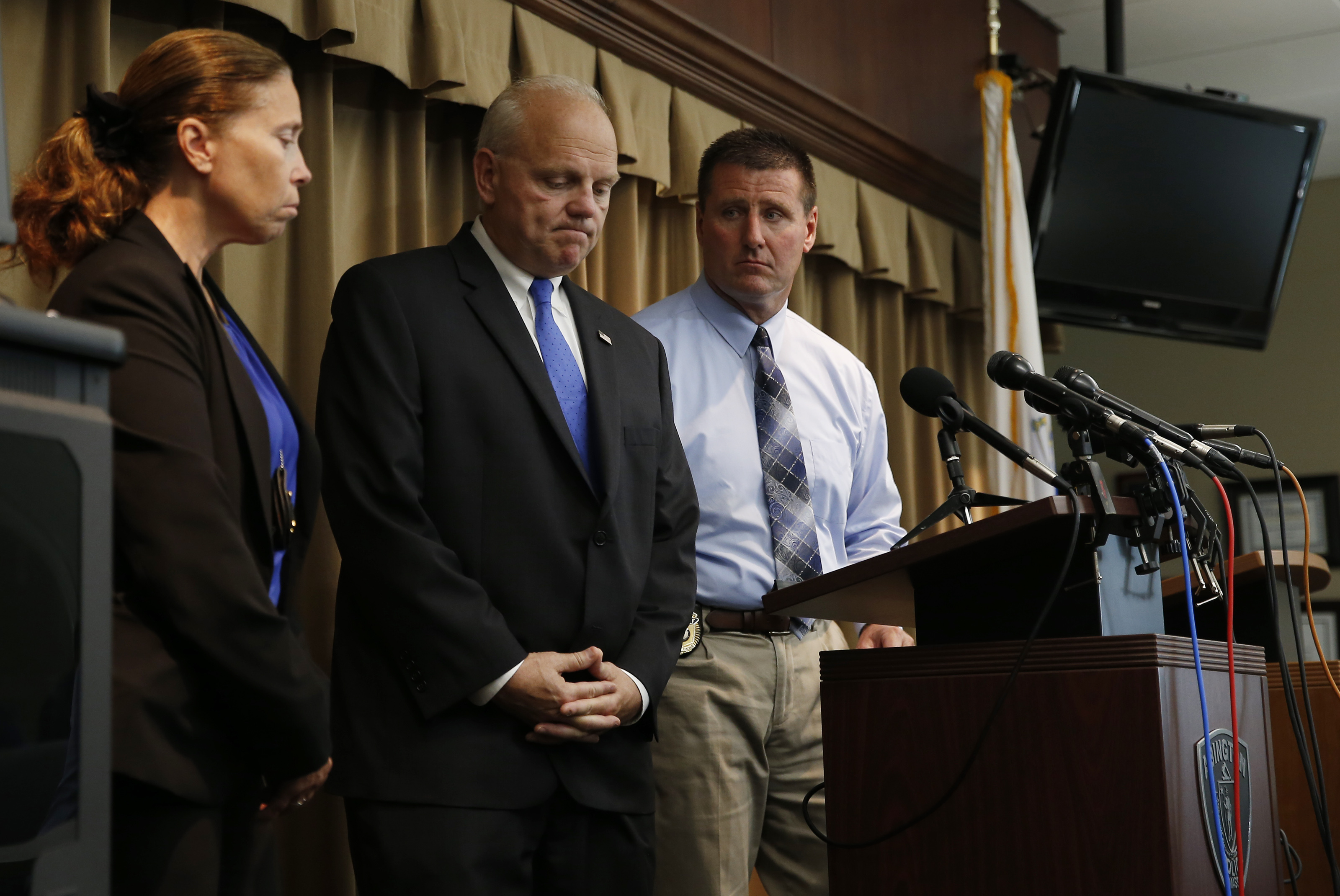 District Attorney Tim Cruz (center) at a press conference after speaking about the discovery of three children and two adults found dead in an Abington condo.