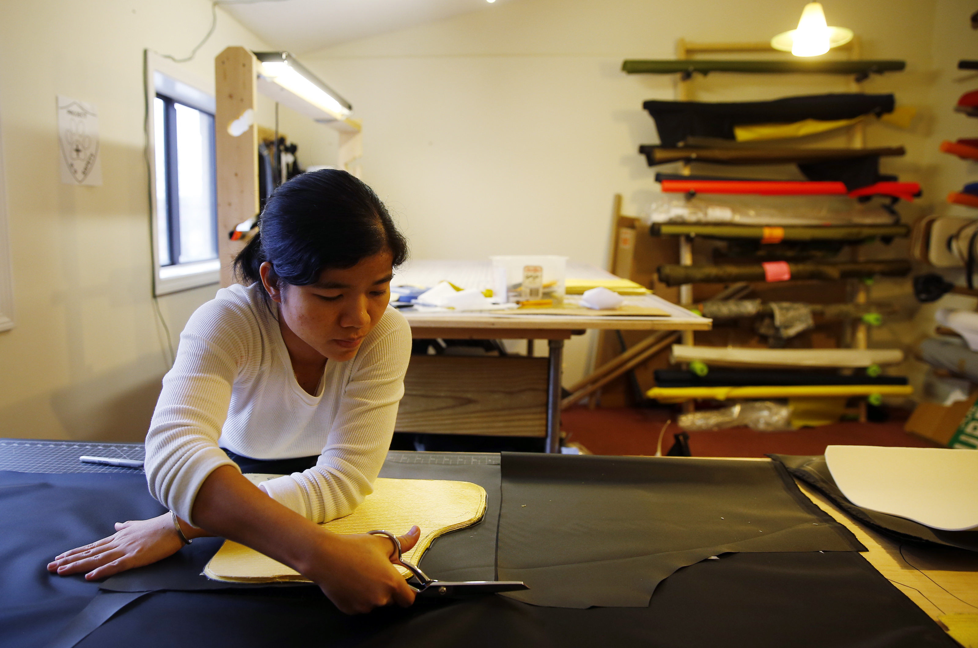 Tham Tran cut patterns for a Bullet Blocker product in Lowell, Massachusetts.