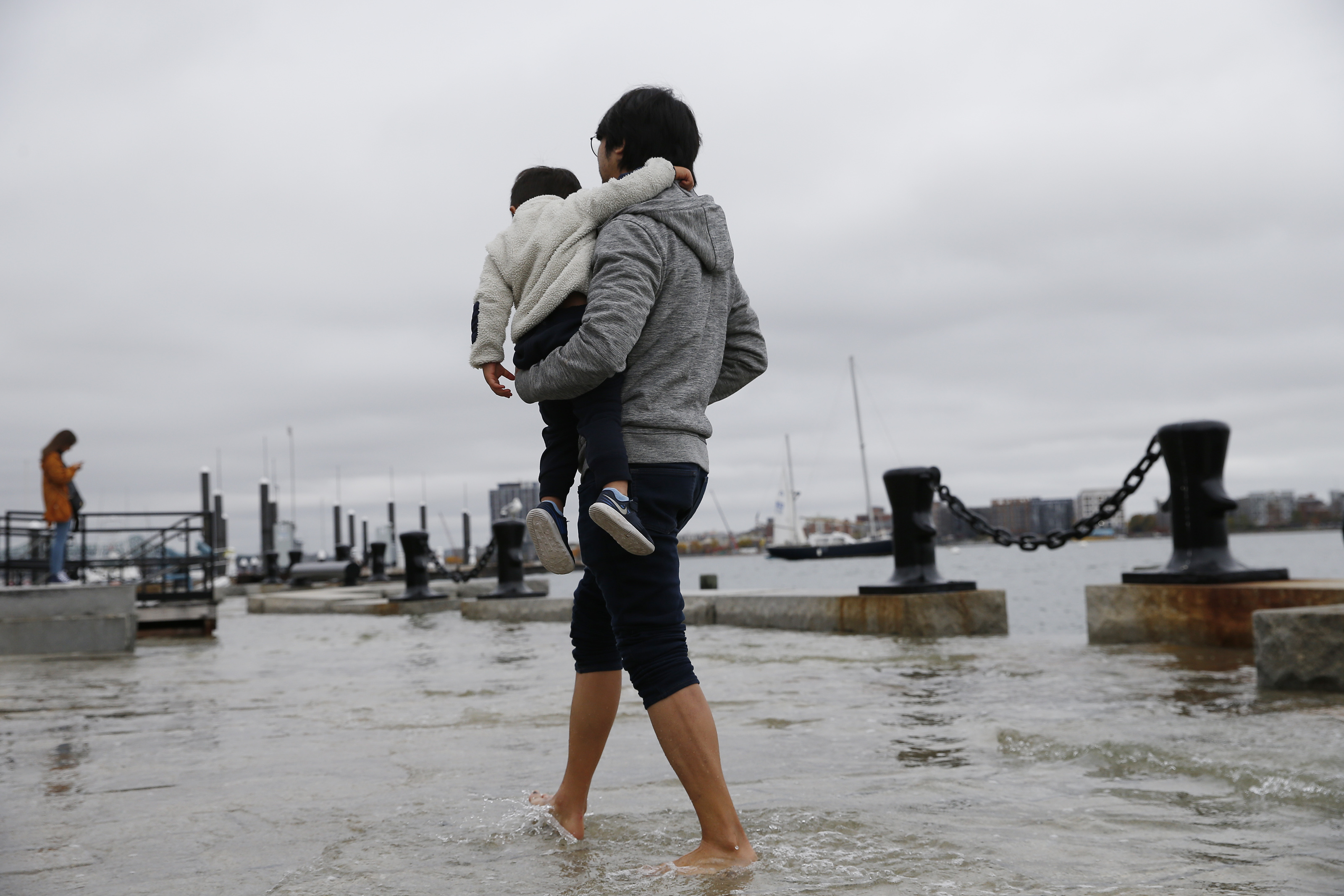 The father and son walked through the water on Long Wharf.