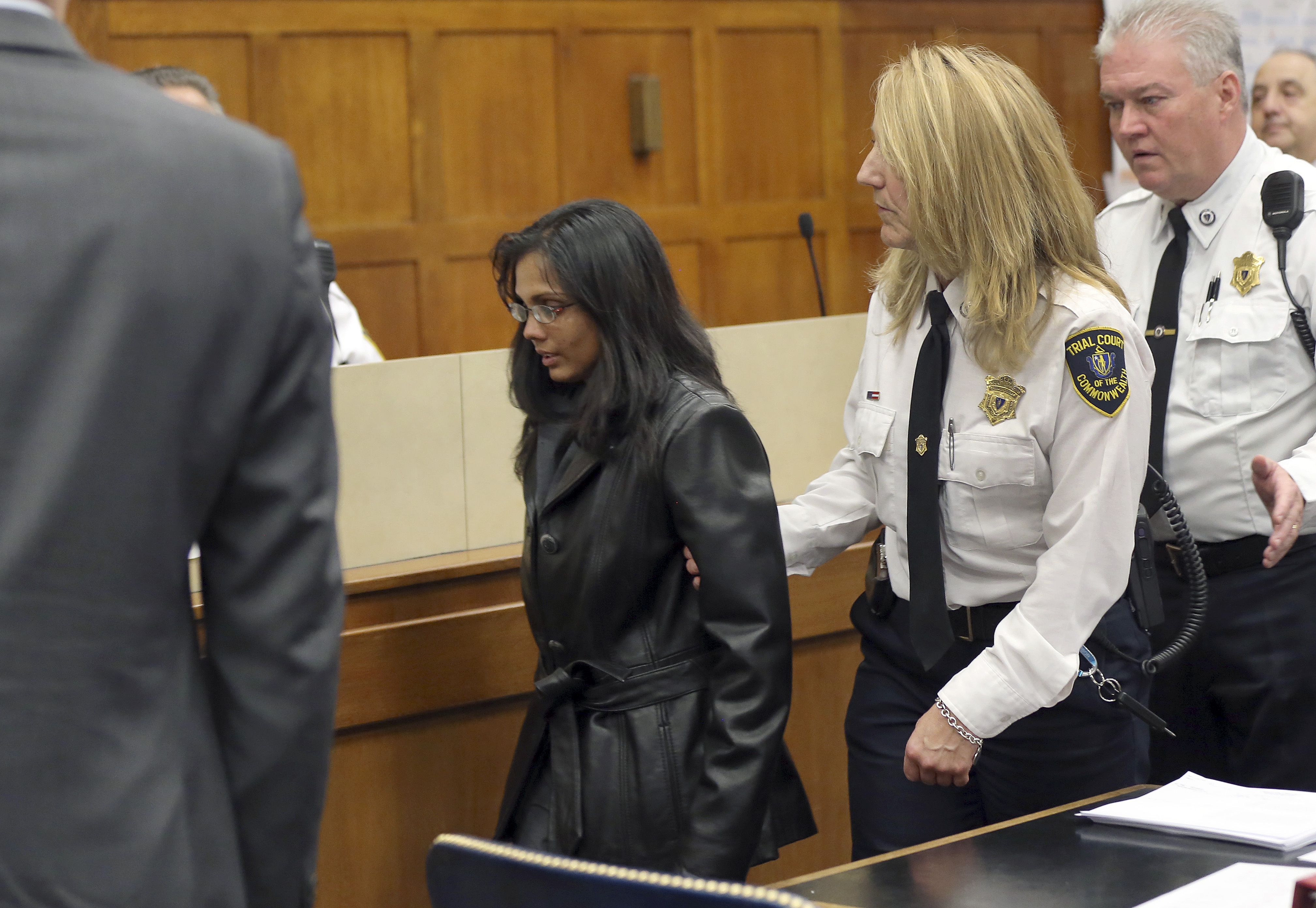 Dookhan was led away by a court officer on Friday after the hearing in Suffolk Superior Court.