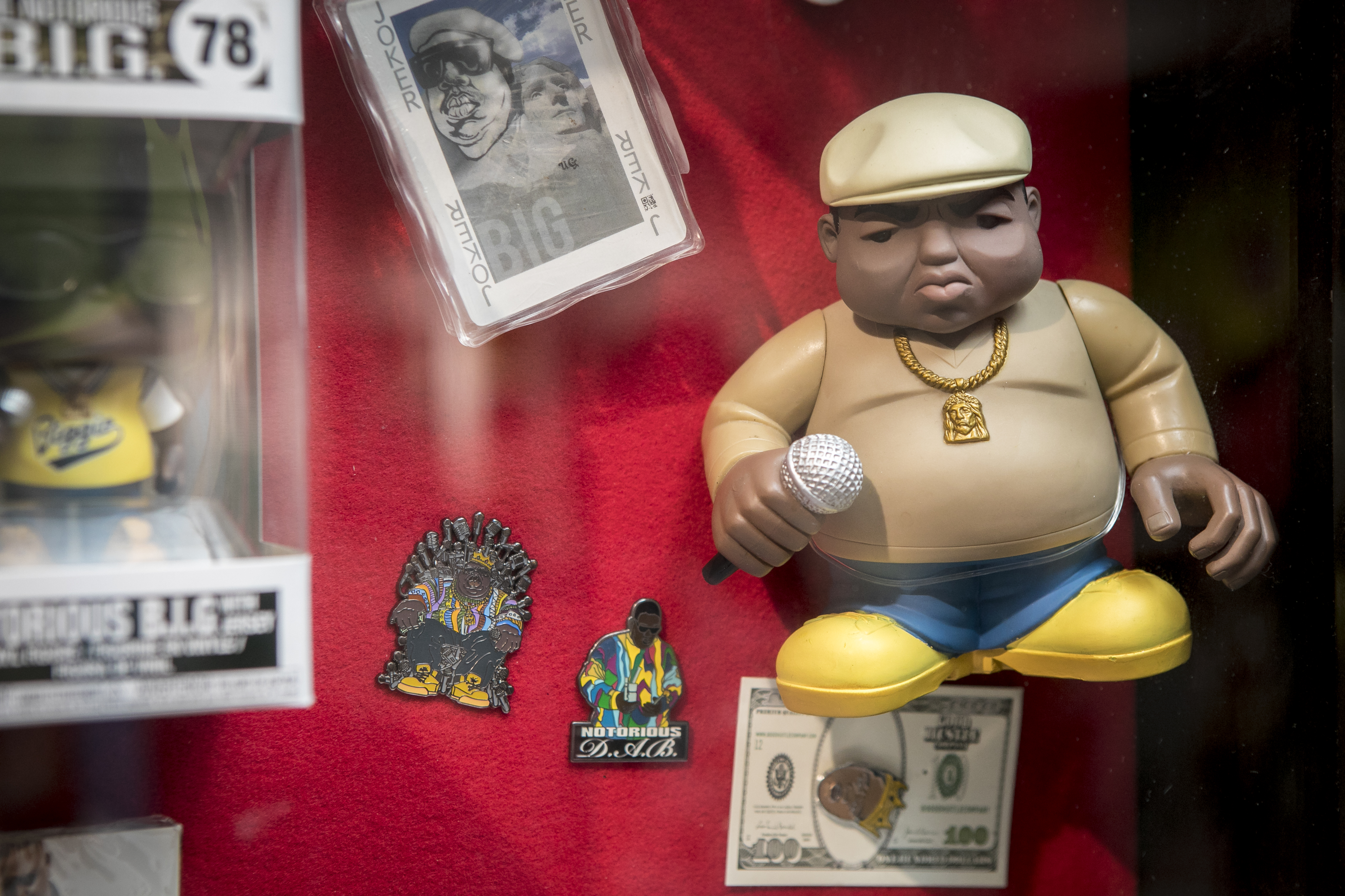 A display of memorabilia, including a Biggie Smalls figure.