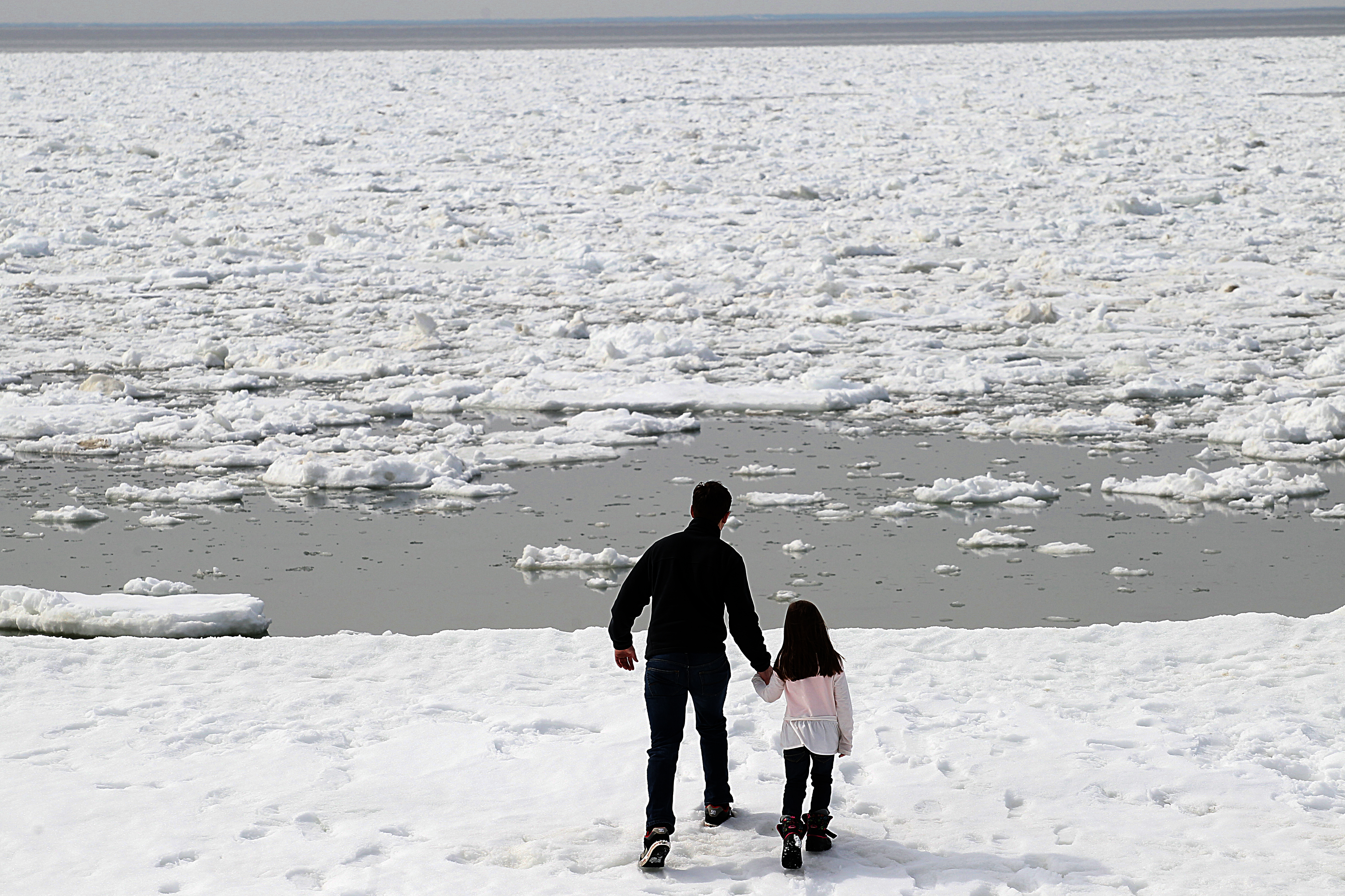 David Caruso of Yarmouth and his six-year-old daughter Riley watched the sea ice in Wellfleet.