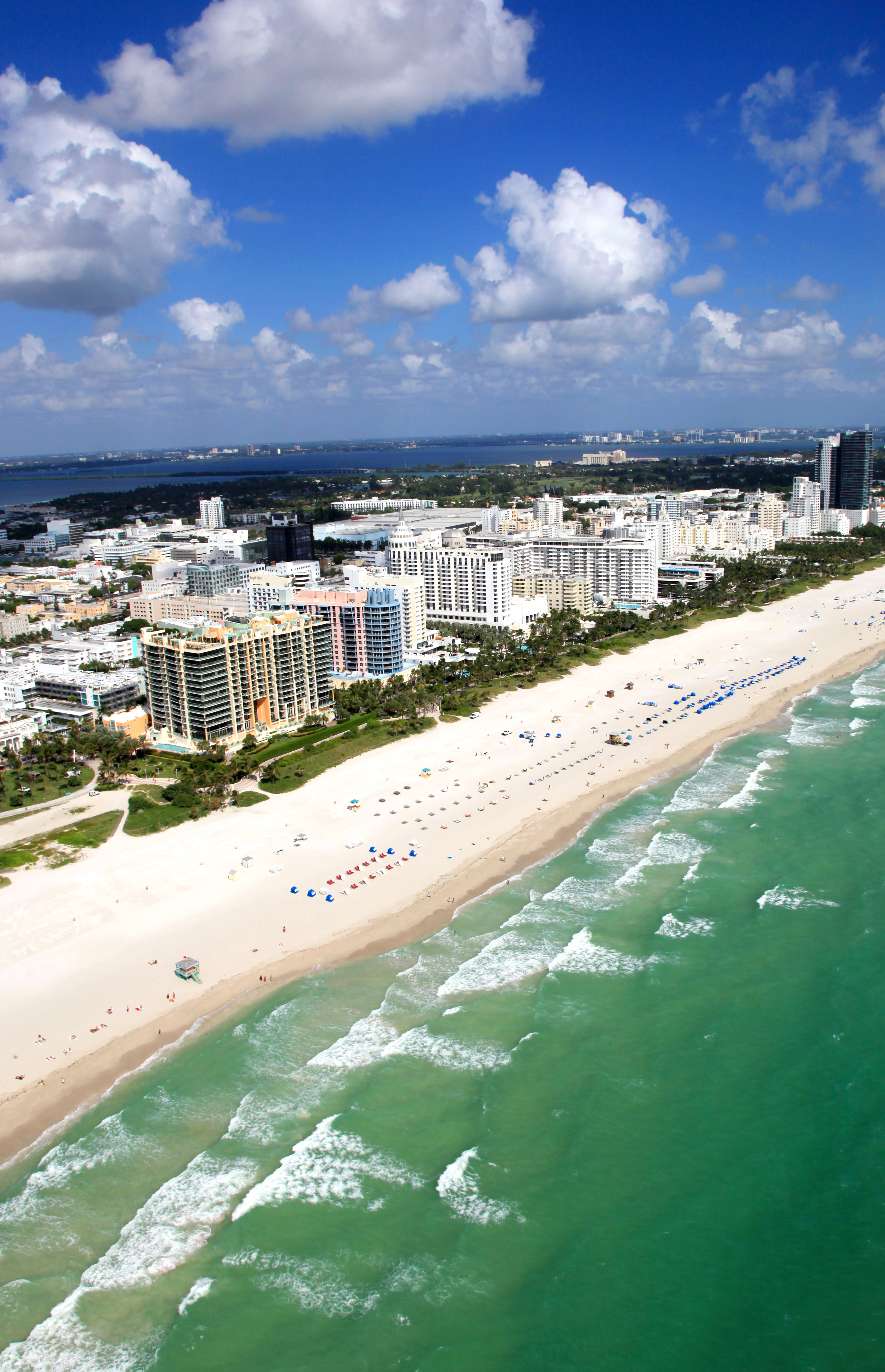 South Beach from the air and the Atlantic Ocean side, the bay and Miami in the background.