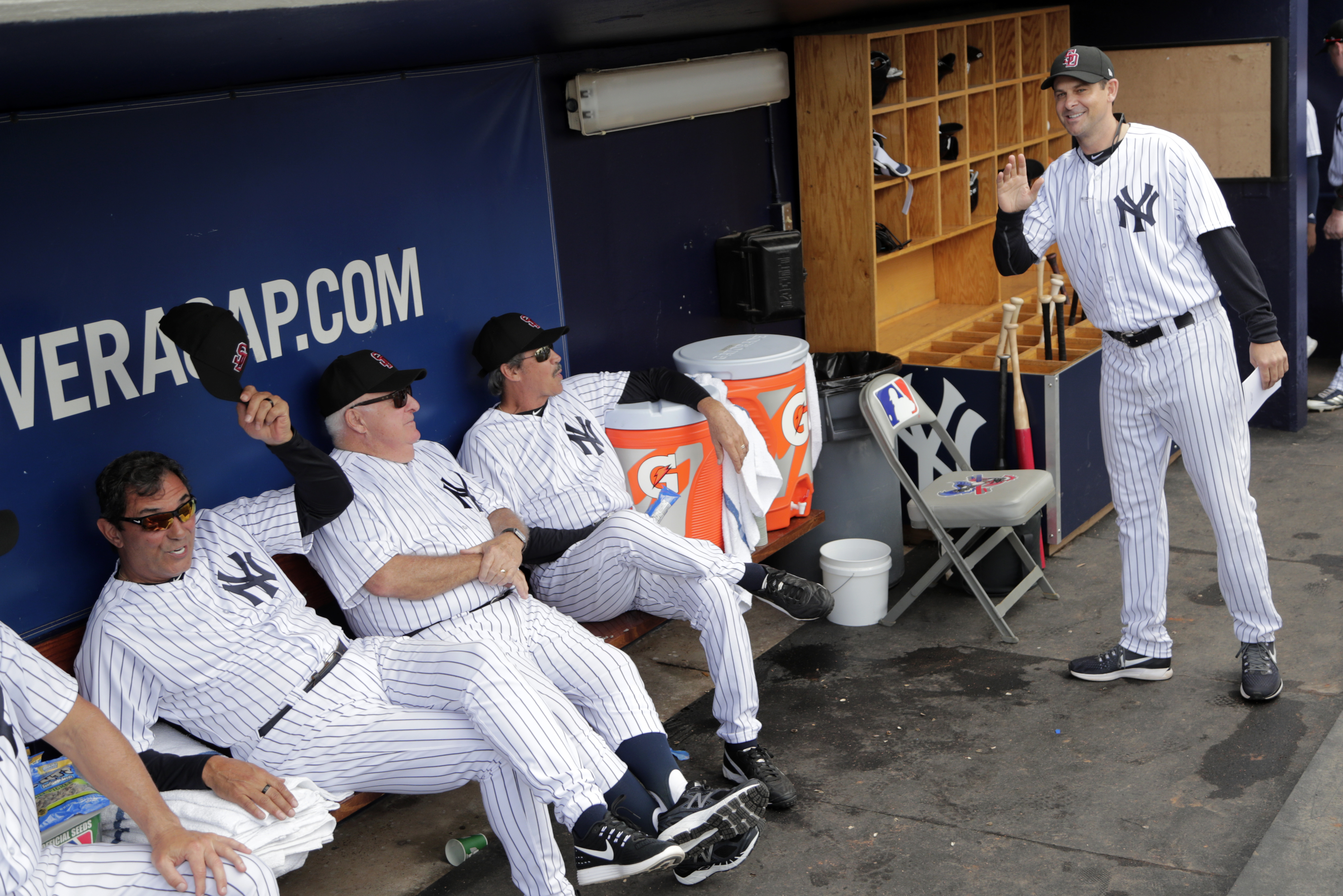 Aaron Boone (right) arrives in the dugout before a spring game last month.